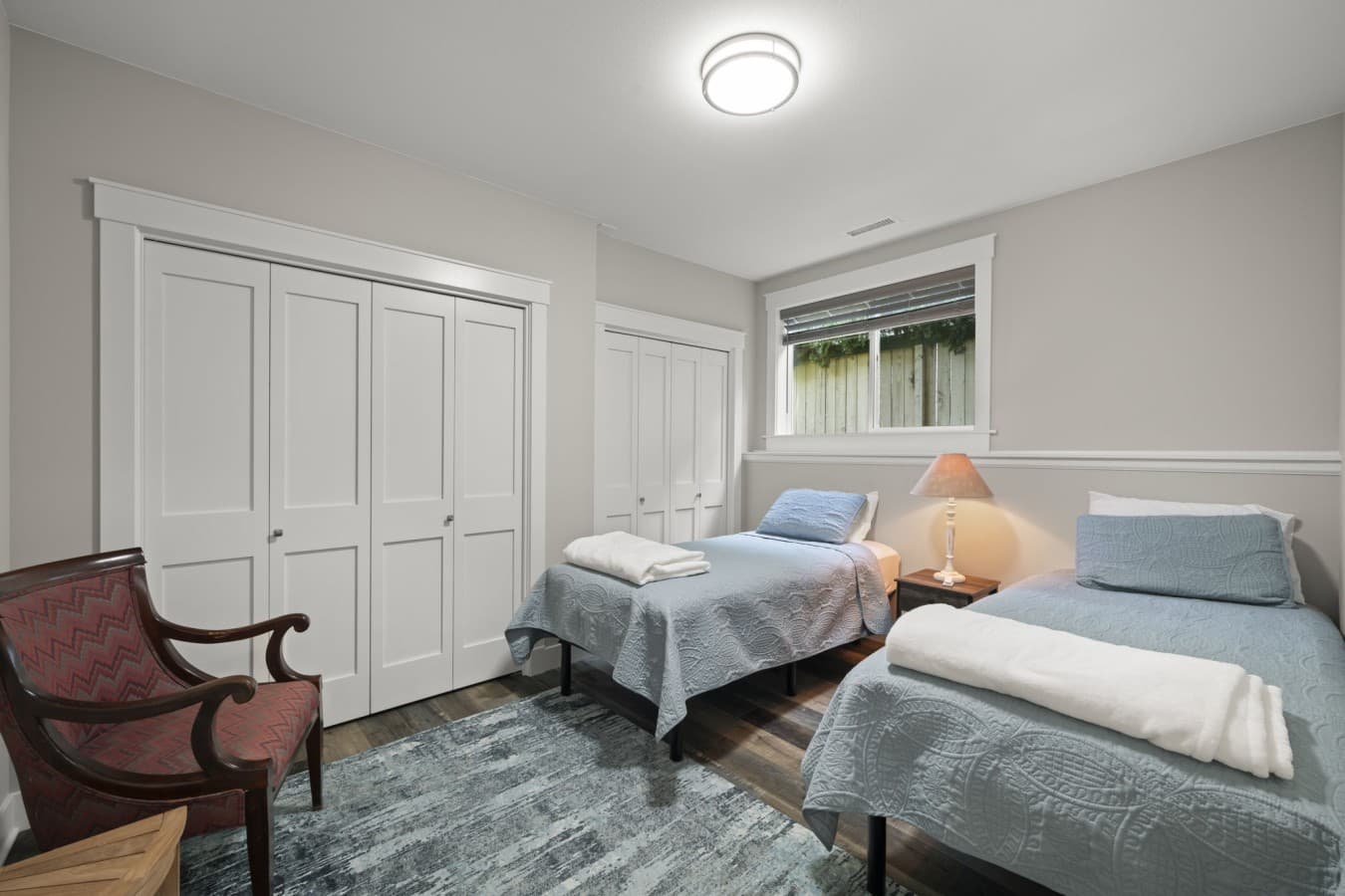 Second bedroom with two comfortable twin-size beds, bedside lighting, and generous closet space_.jpg