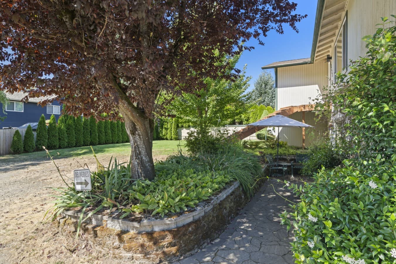 Peaceful garden setting with mature trees, lush landscaping, and a private walkway_.jpg