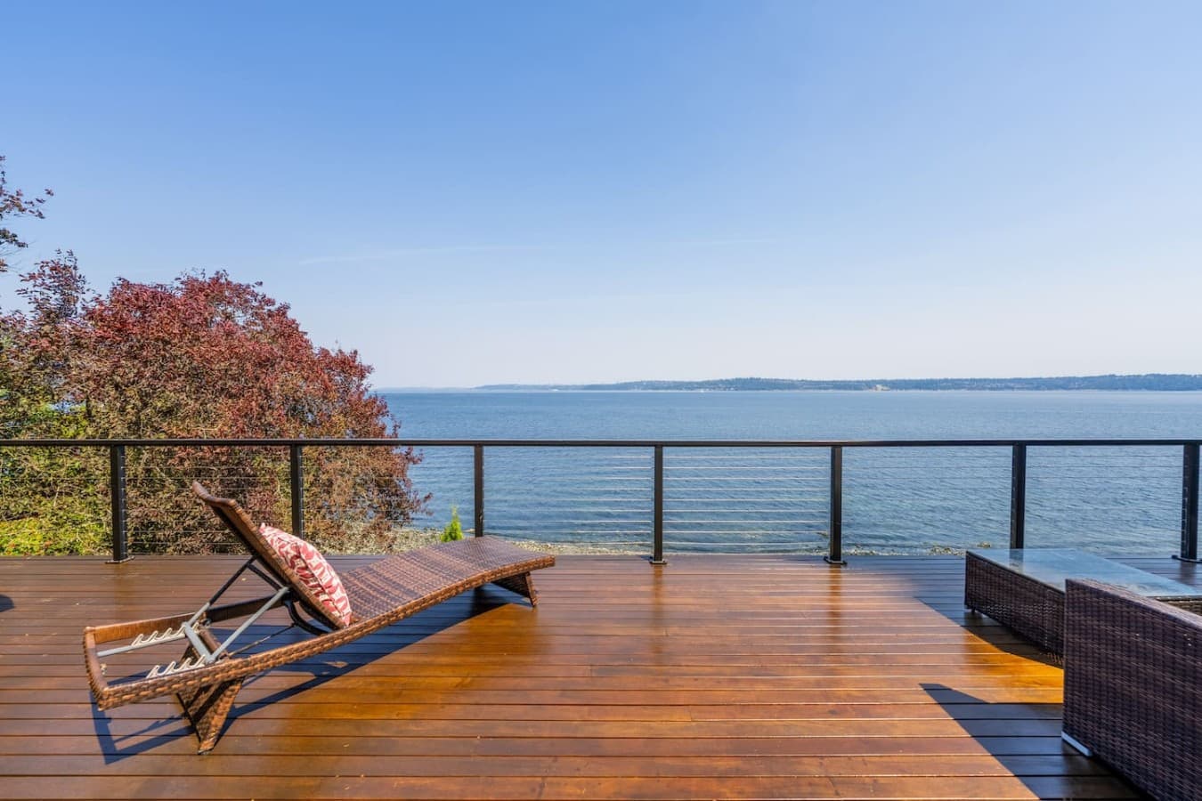 Unwind on the expansive waterfront deck, where panoramic views and peaceful blue horizons set the scene for effortless relaxation.