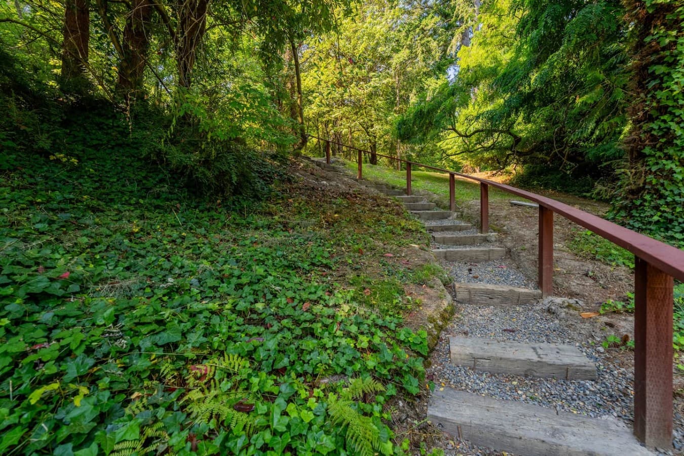 A peaceful wooded pathway surrounded by lush greenery—your private connection to the natural beauty surrounding Sea and Sky.