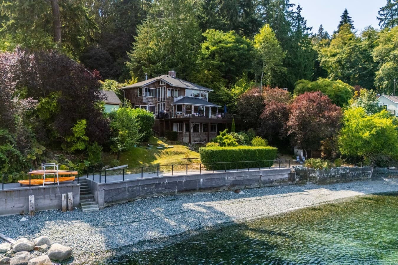 Sea and Sky sits right along the shoreline, surrounded by lush greenery with direct beach access just steps from the home.