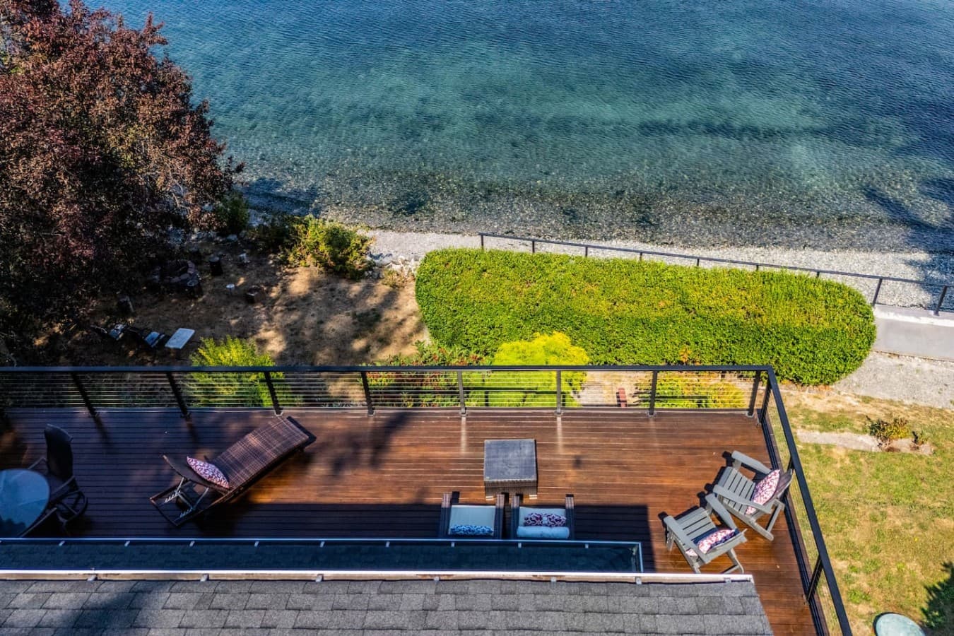 An expansive waterfront deck perched just above the shoreline—perfect for lounging, gathering, and soaking in the incredible water views.