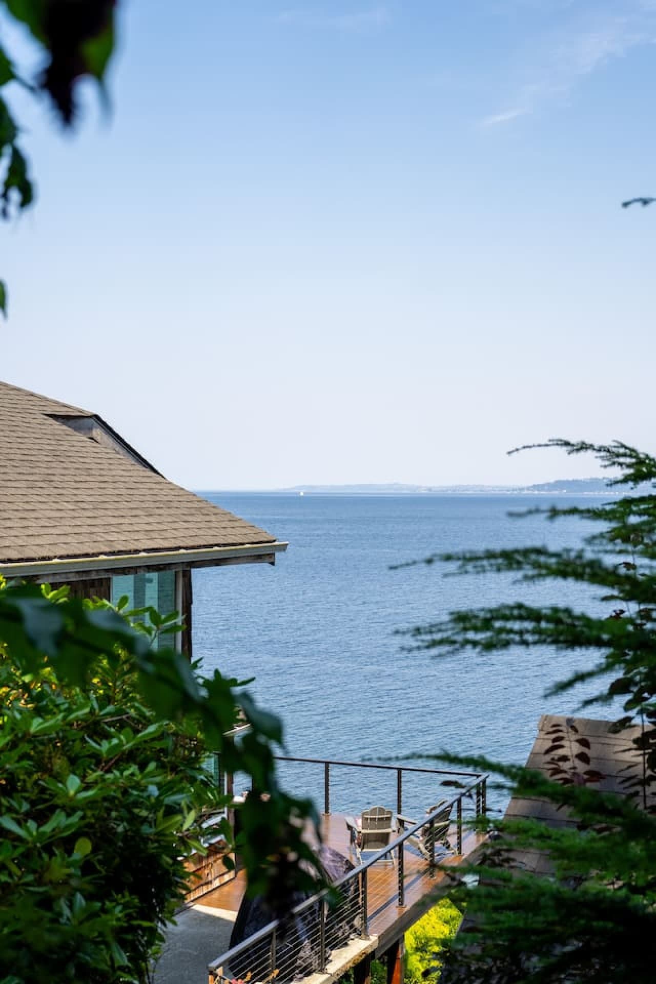 A tucked-away waterfront retreat with sweeping water views peeking through the trees—peaceful, private, and unmistakably Sea and Sky.
