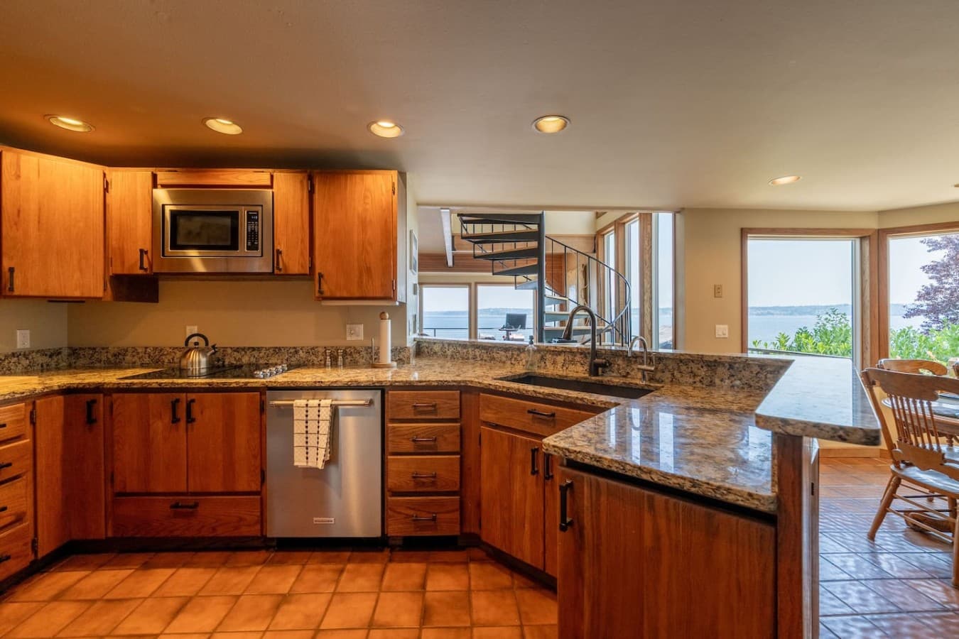 A warm, well-equipped kitchen with granite countertops and plenty of space for preparing meals together.