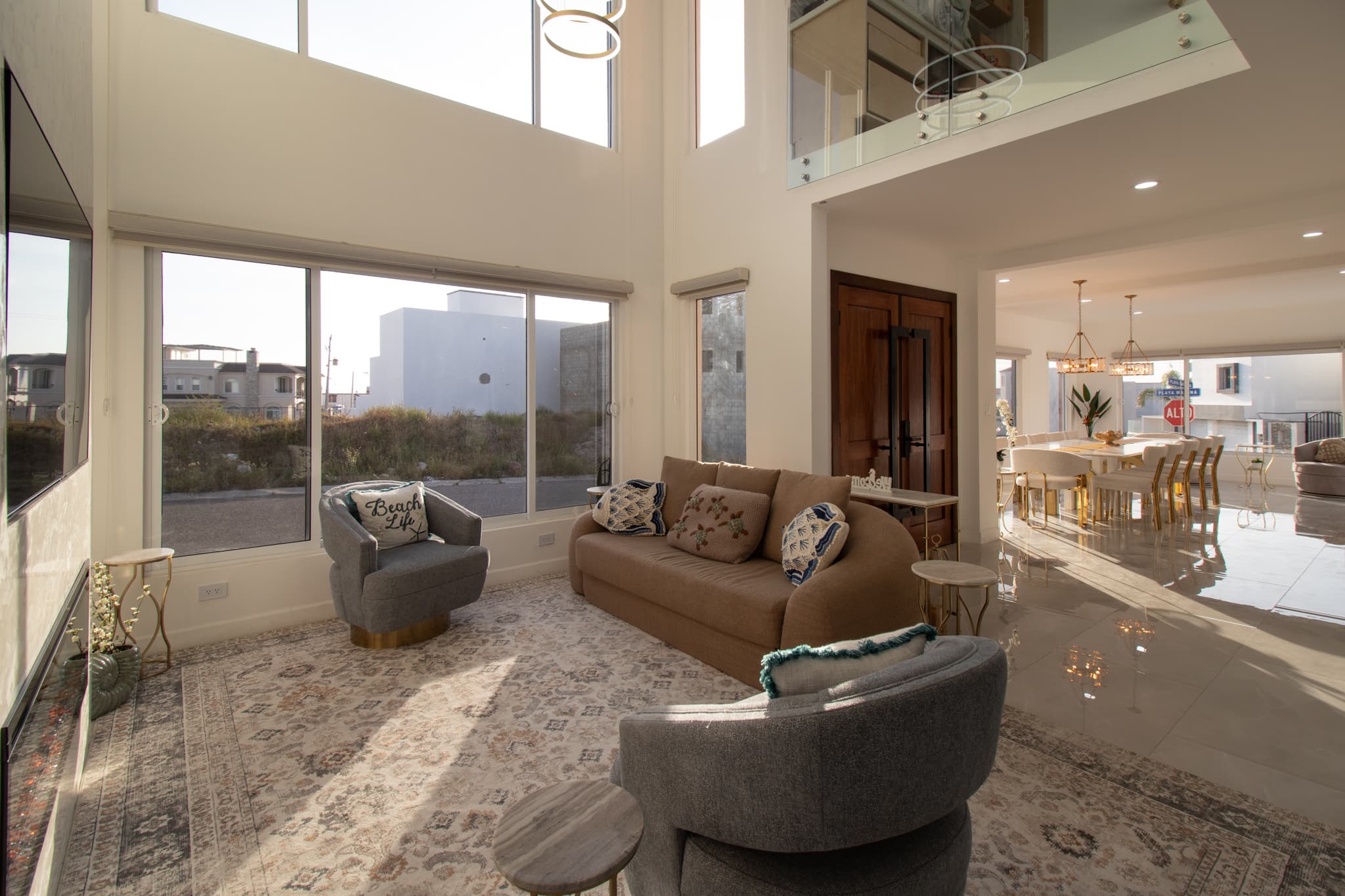 Soaring two-story great room with floor-to-ceiling windows & plenty of space to gather