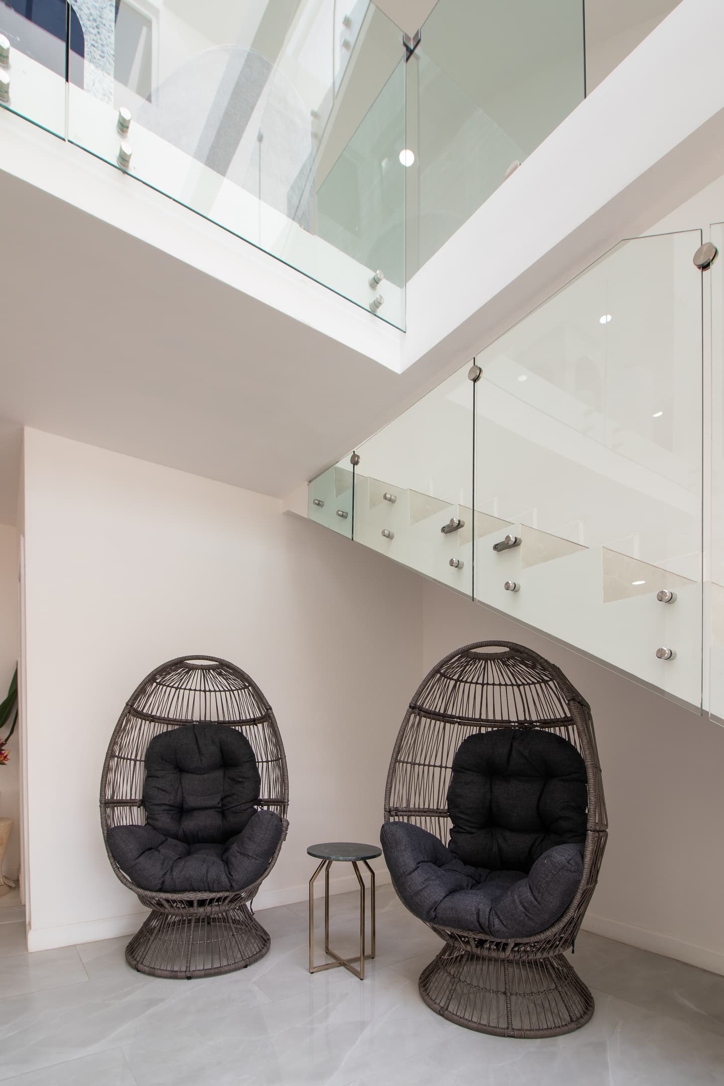 Cozy indoor garden lounge with egg chairs, a peaceful spot for coffee or conversation
