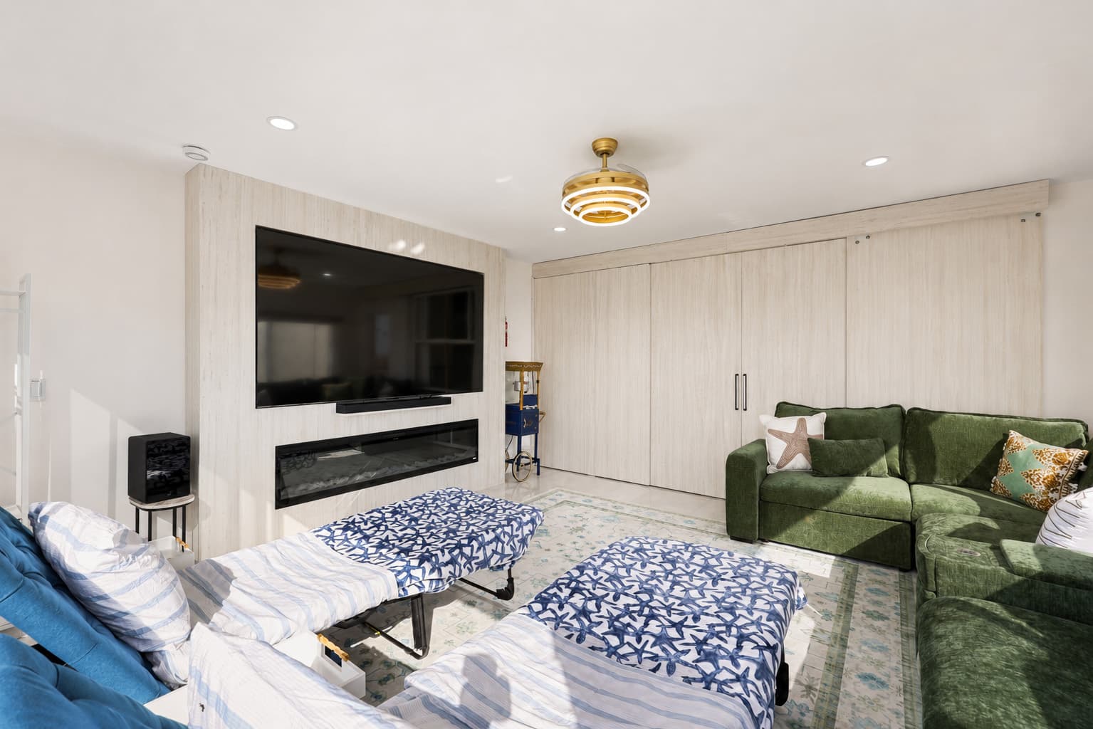 Movie room converts into a bedroom with sliding doors for privacy, and two twin beds