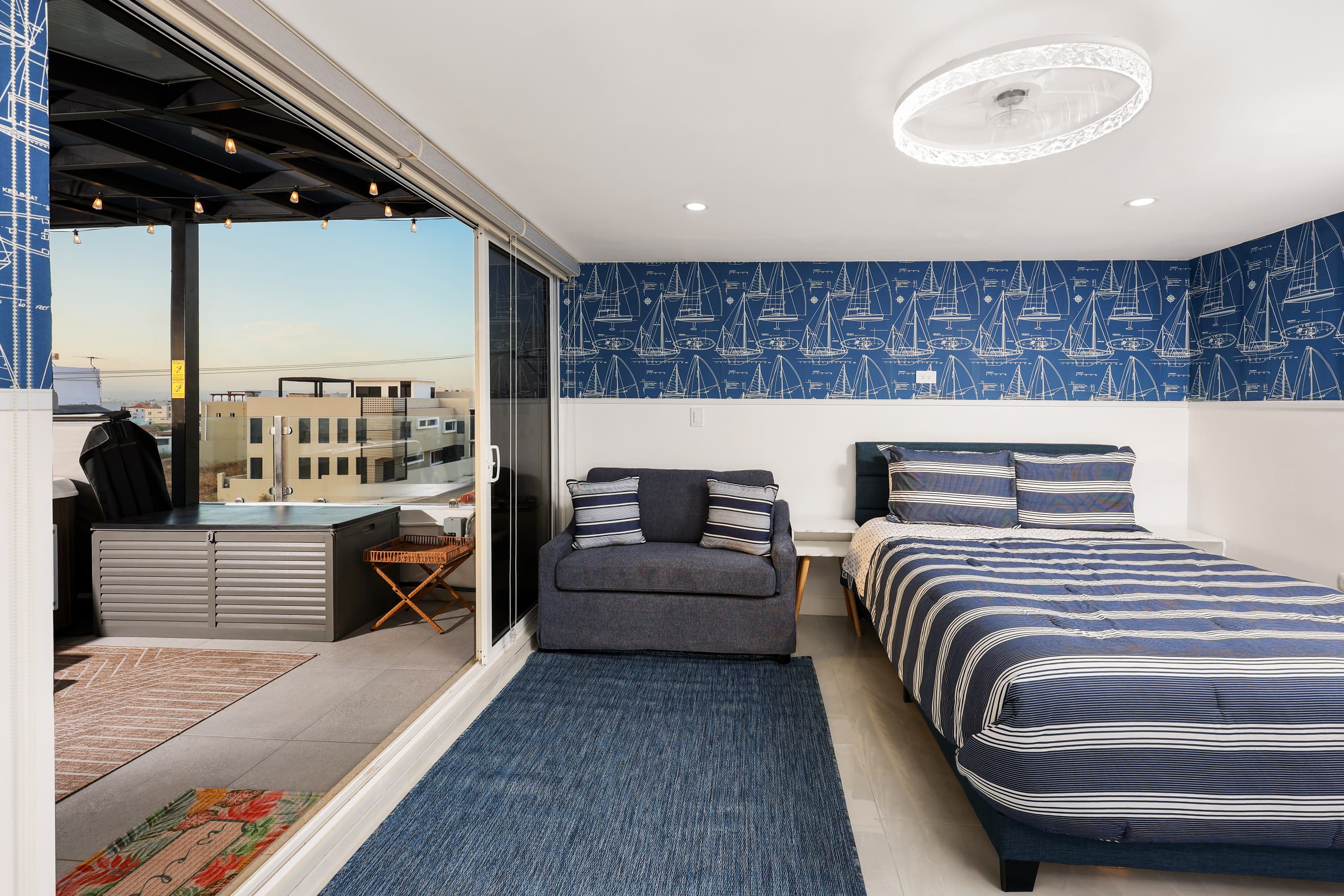 Third-floor queen bedroom with sleeper sofa, ensuite bathroom & direct terrace access