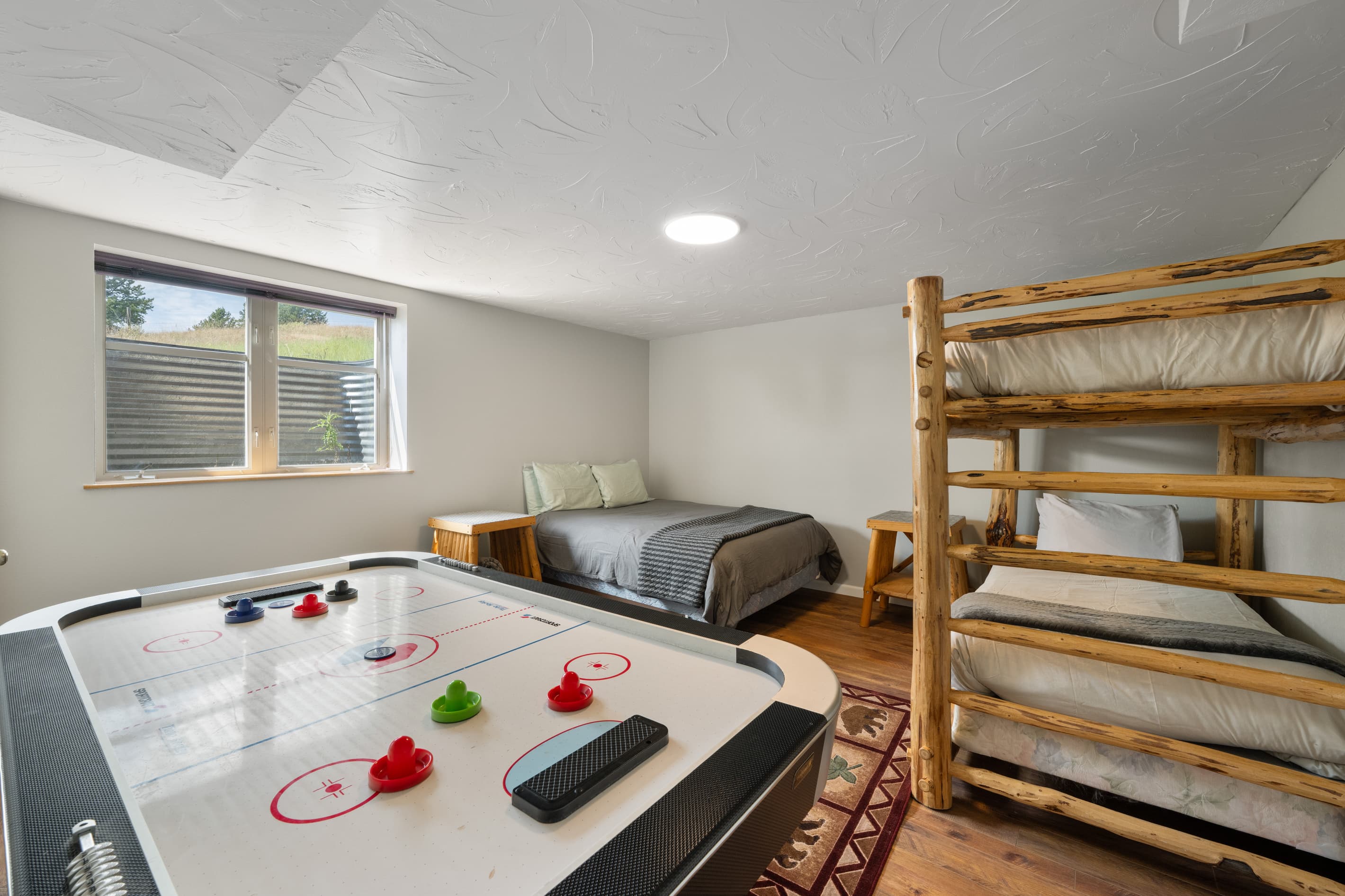 Bedroom 4: Lower bunk room with Queen bed & bunk beds, plus air hockey table.