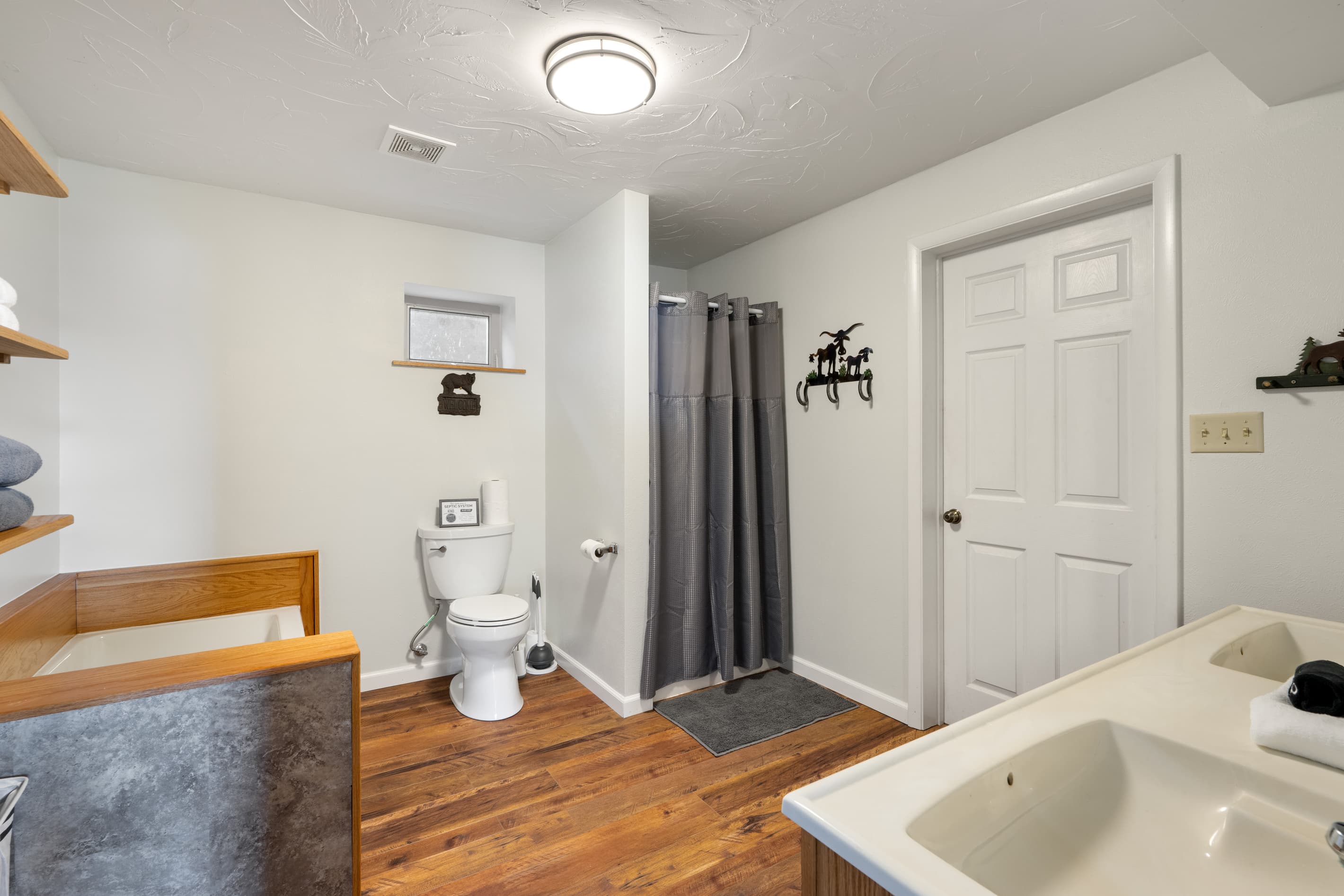 Lower full bathroom - door leads to laundry room for dropping wet gear. 