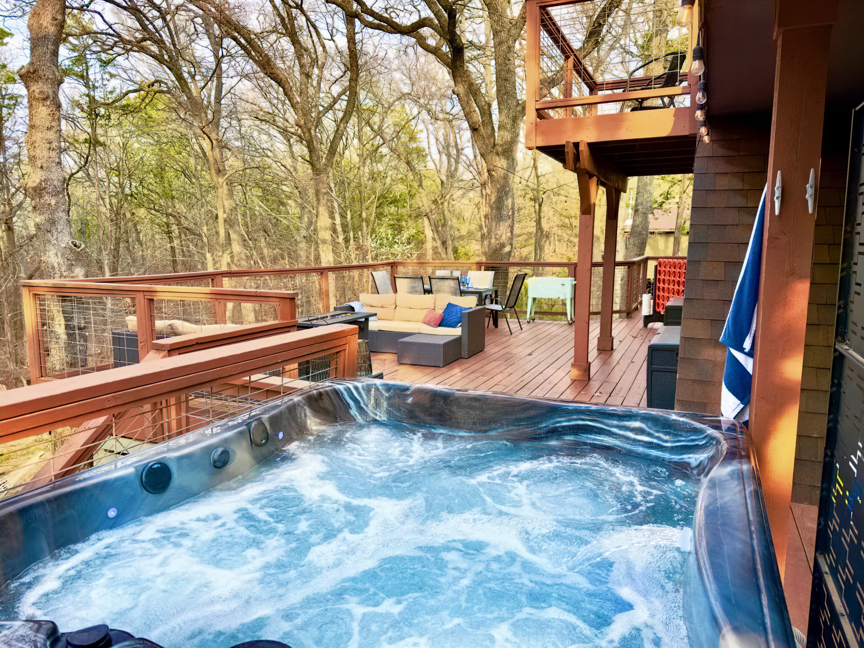 800 sf Deck | Tabletop Fire Pit (Propane Provided) | Outdoor Cooler | Private Hot Tub for 4 people with Speaker | Private Wooded Views | String Lights