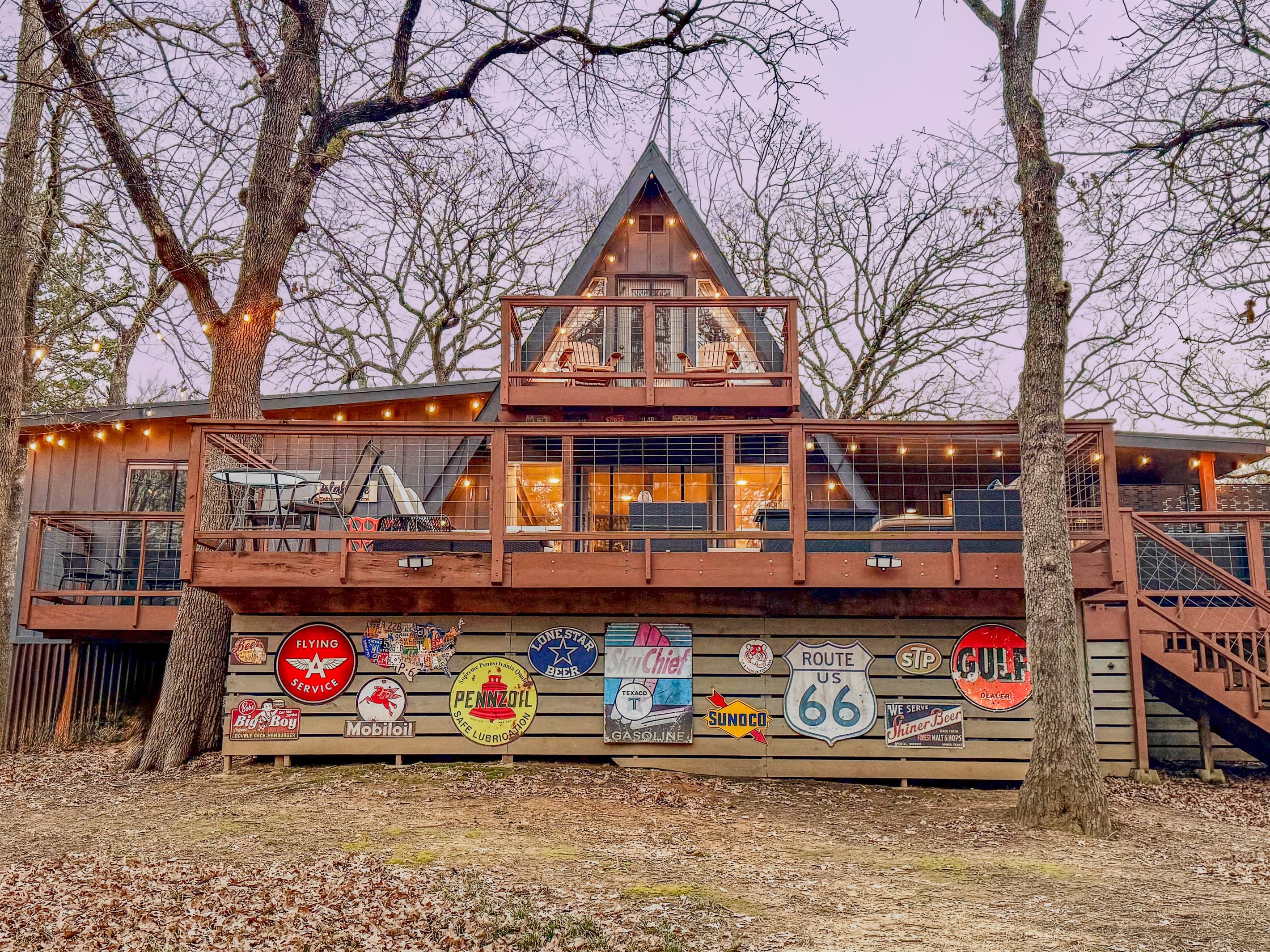 Enjoy the string lights in the evening and a beautiful sunset | Retro Signs Encase the Storage Area with 2 Kayaks & Frisbee Golf