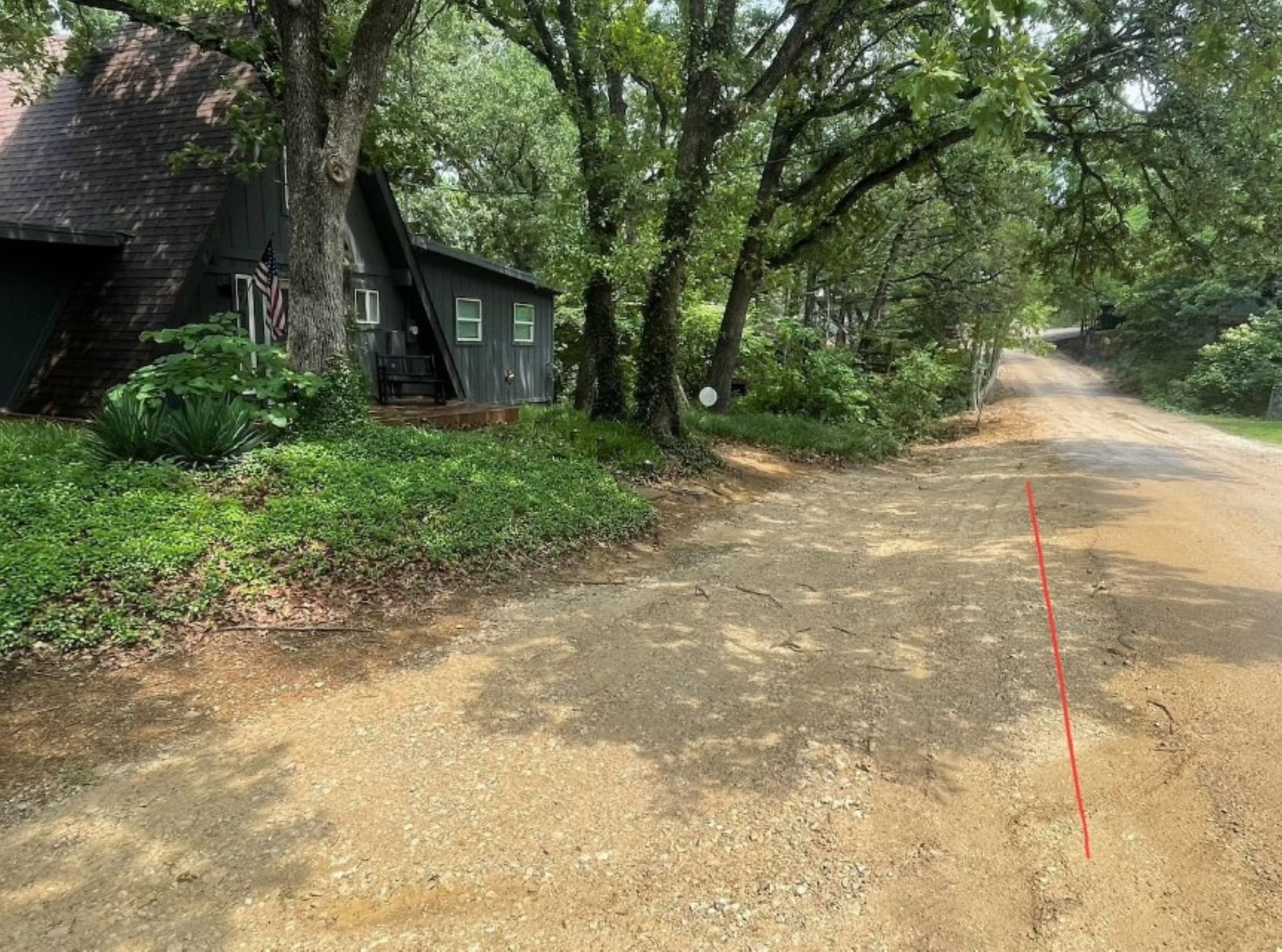 Parking in front of the house, just off the street (left of the red line), adequate for 2 car-lengths or a car and a trailer. 