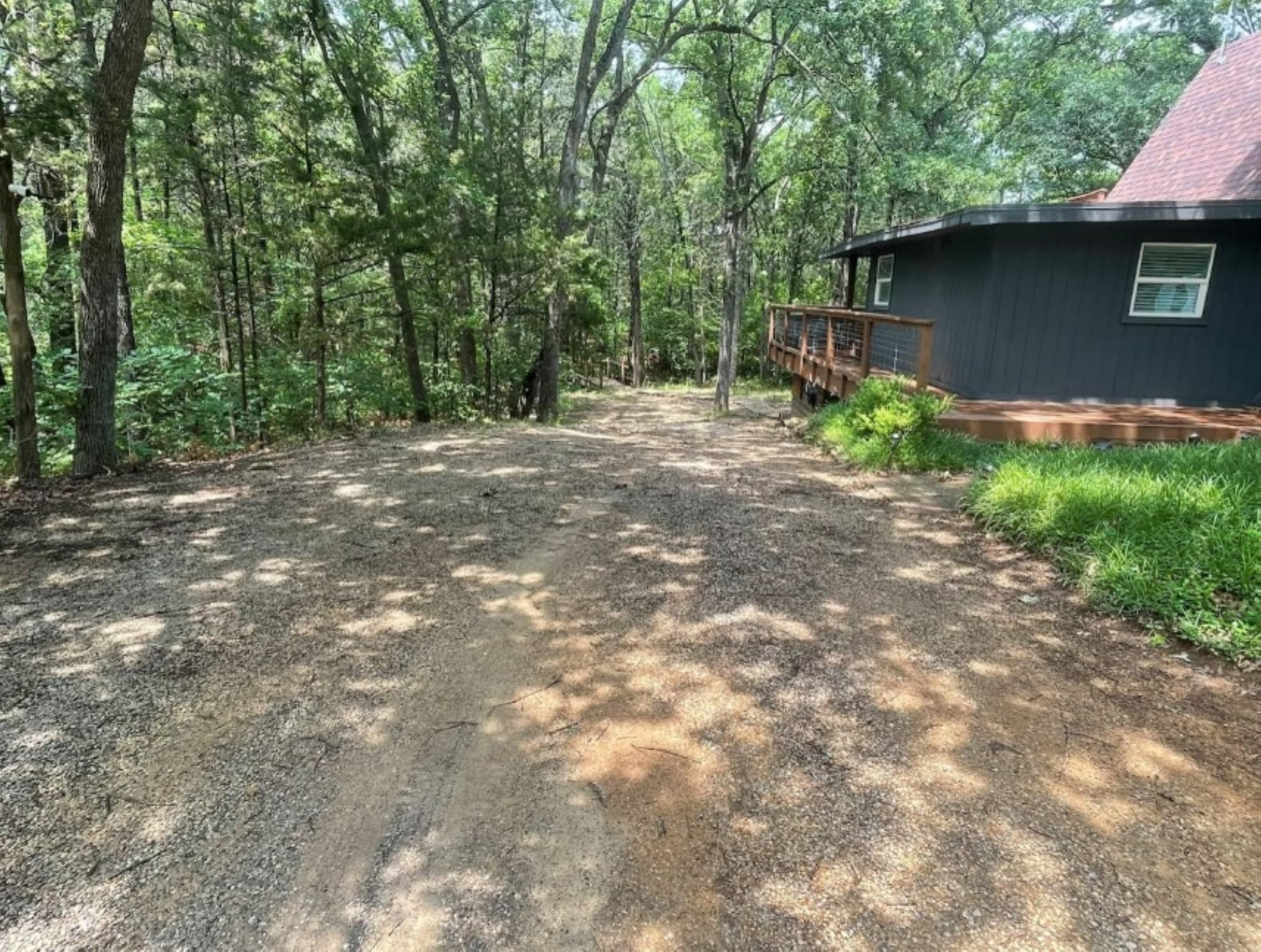 Driveway extends from the street back to the bridge walkway. Total parking is 6 cars or 5 cars and a boat trailer. 
