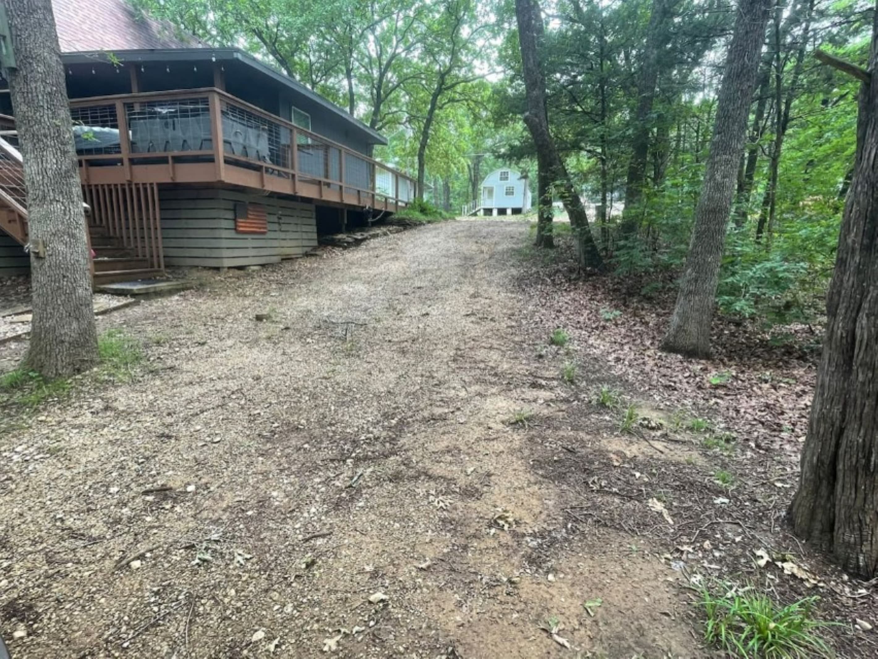 Driveway extends from the street back to the bridge walkway. Total parking is 6 cars or 5 cars and a boat trailer. 