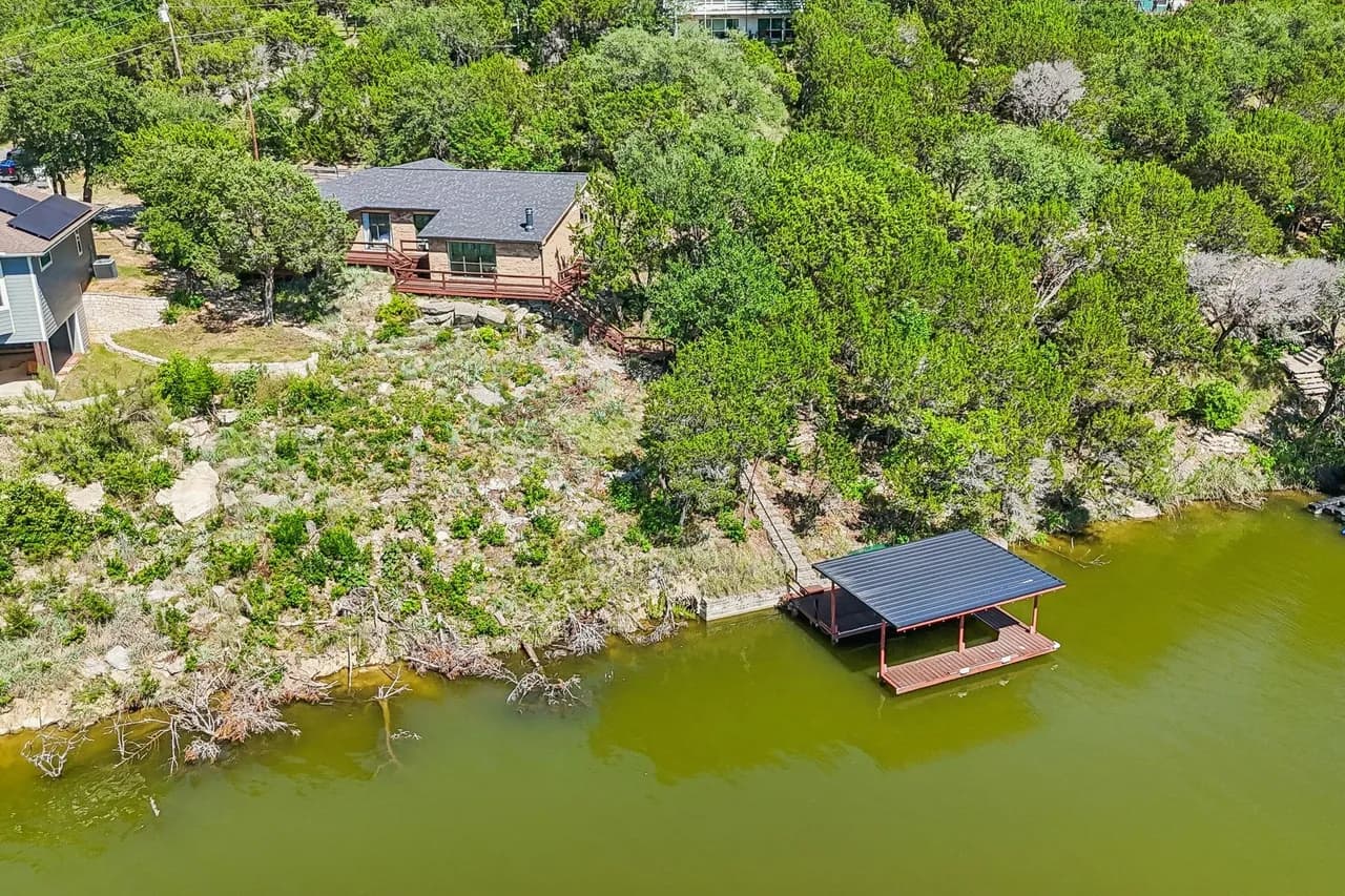 Private lakefront home surrounded by mature trees.