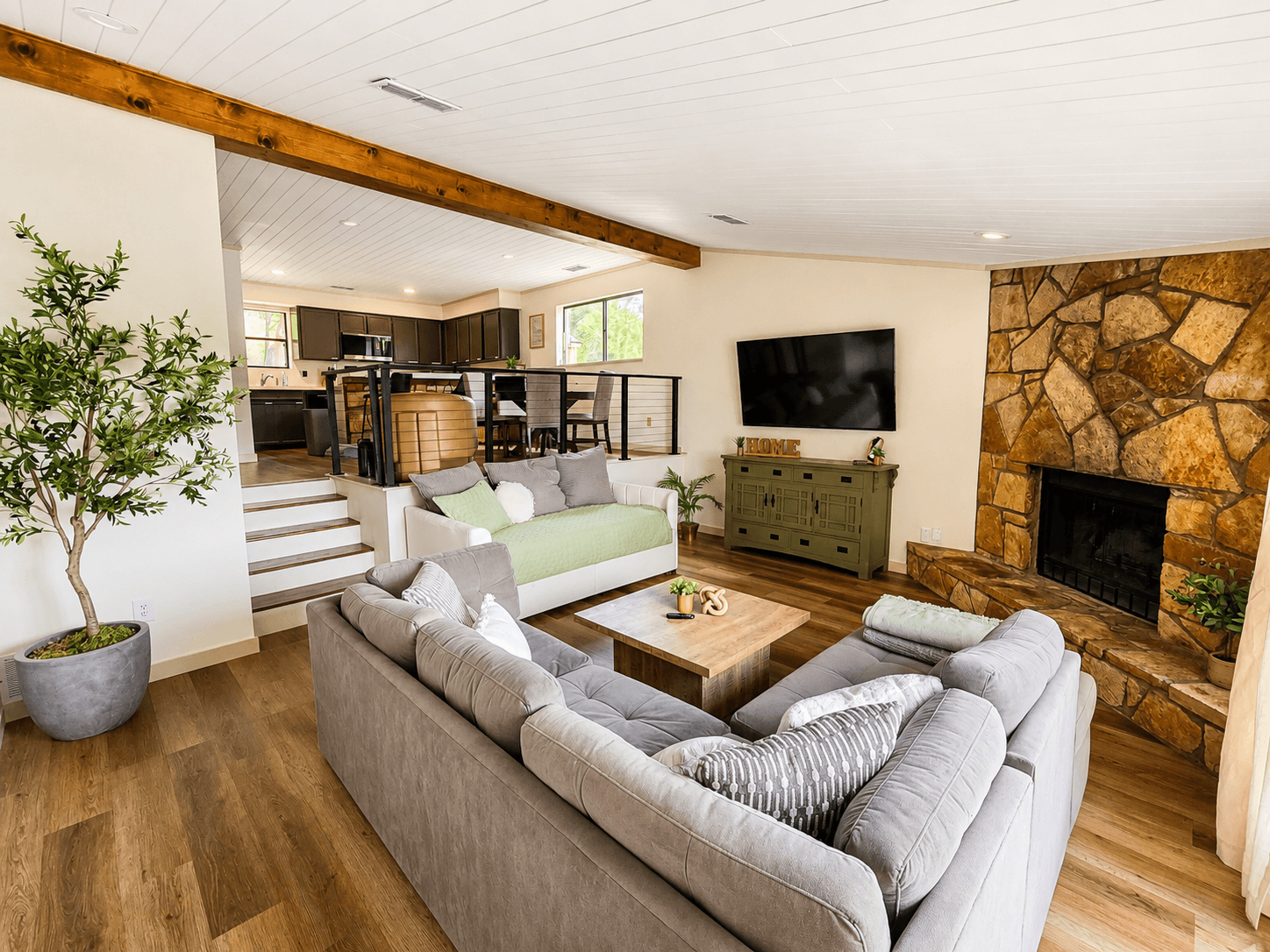 Open living room with fireplace and panoramic lake views.