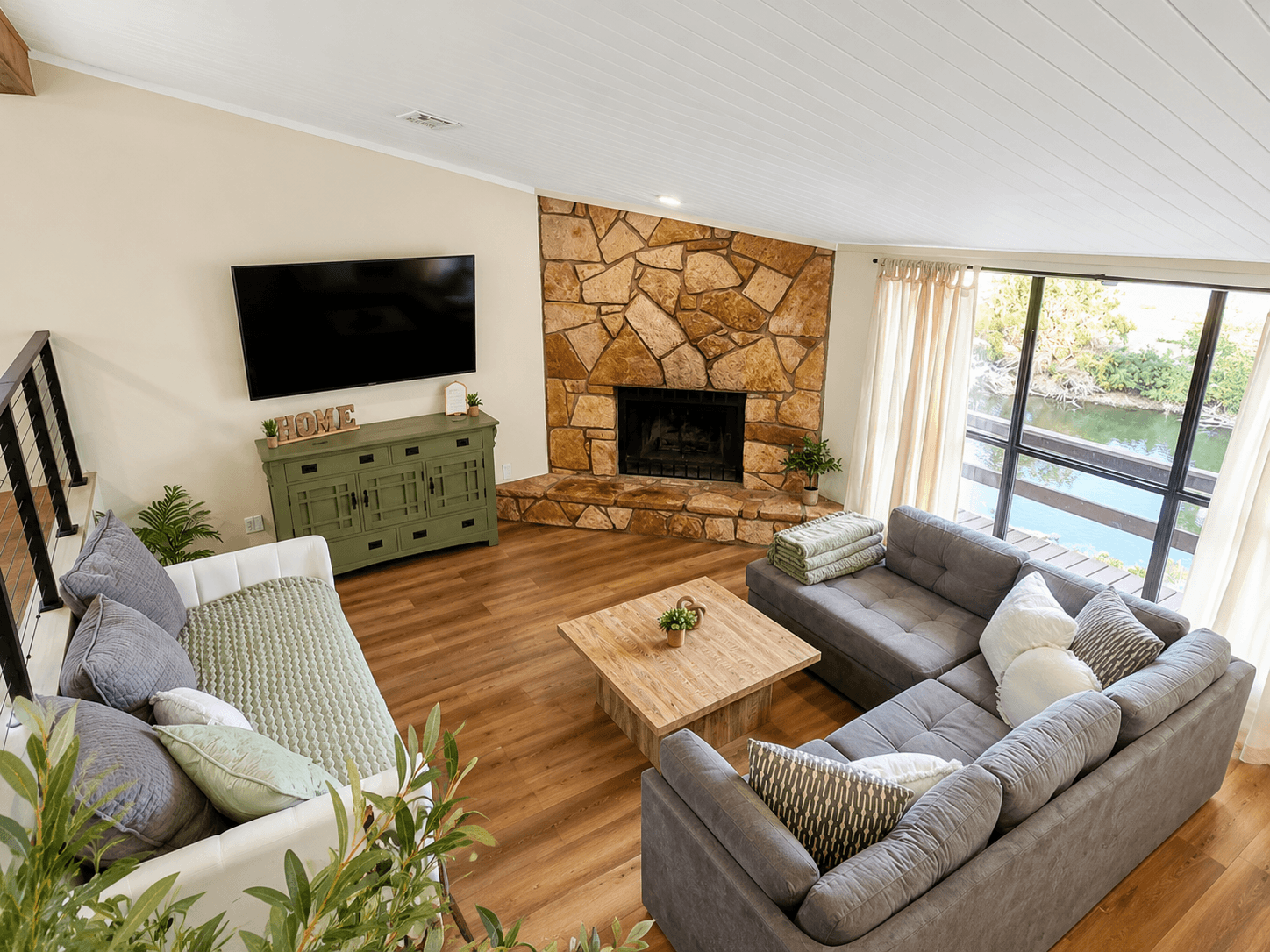 Open living room with fireplace and panoramic lake views.