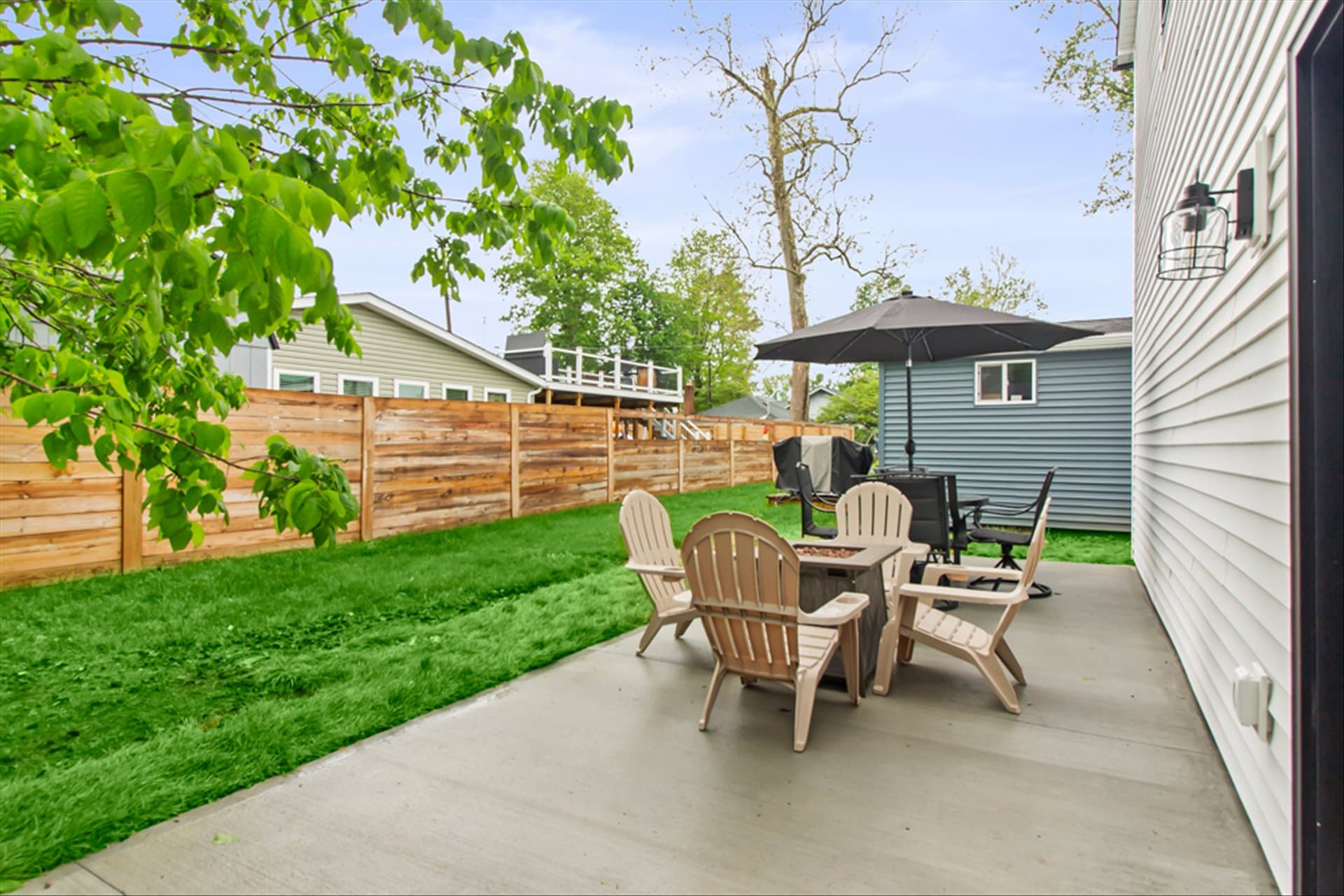 The Loft on Waterbury - Patio Area with fire pit, outdoor dining and Blackstone grill