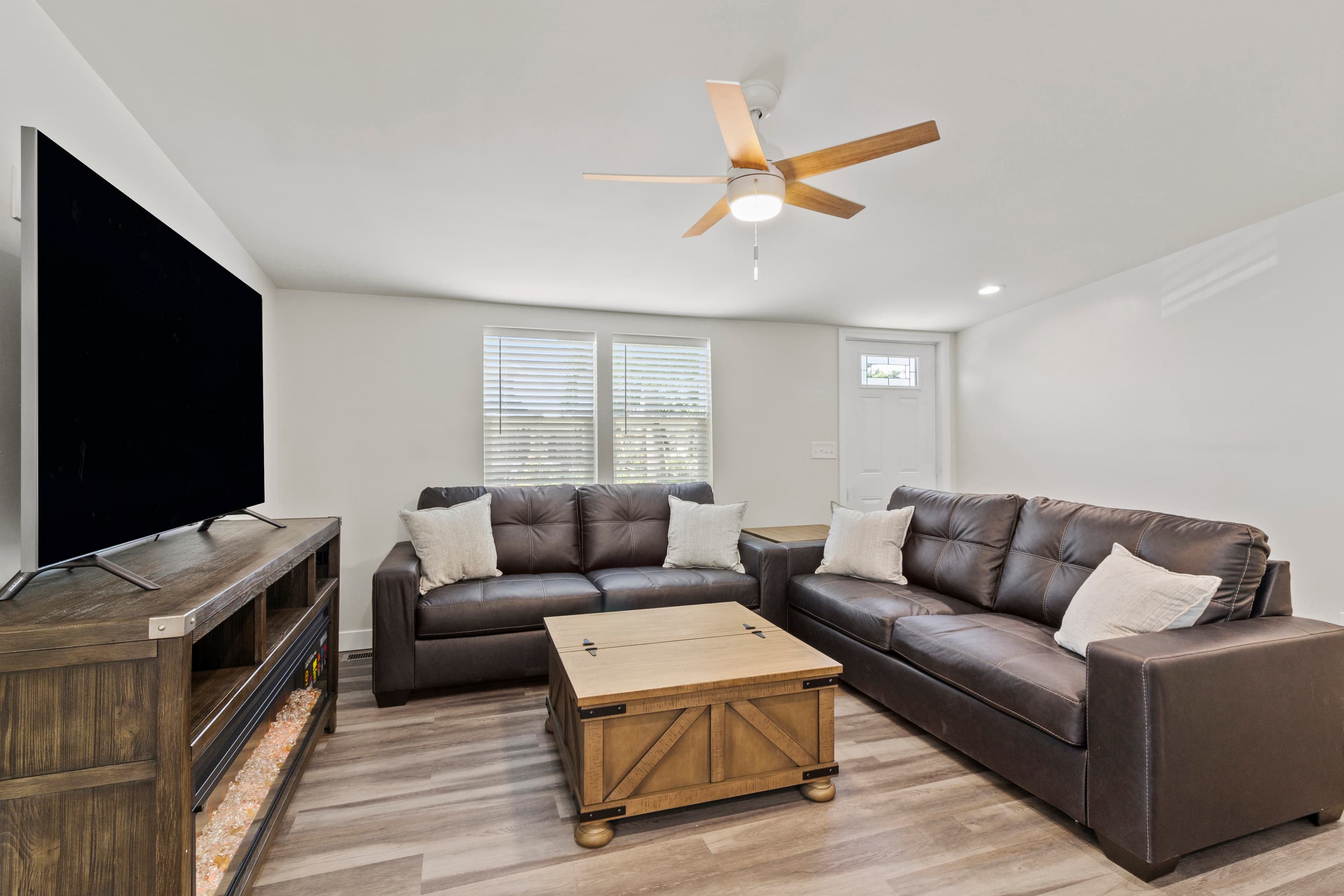 The Waterbury Way - Living Room showing couches and TV