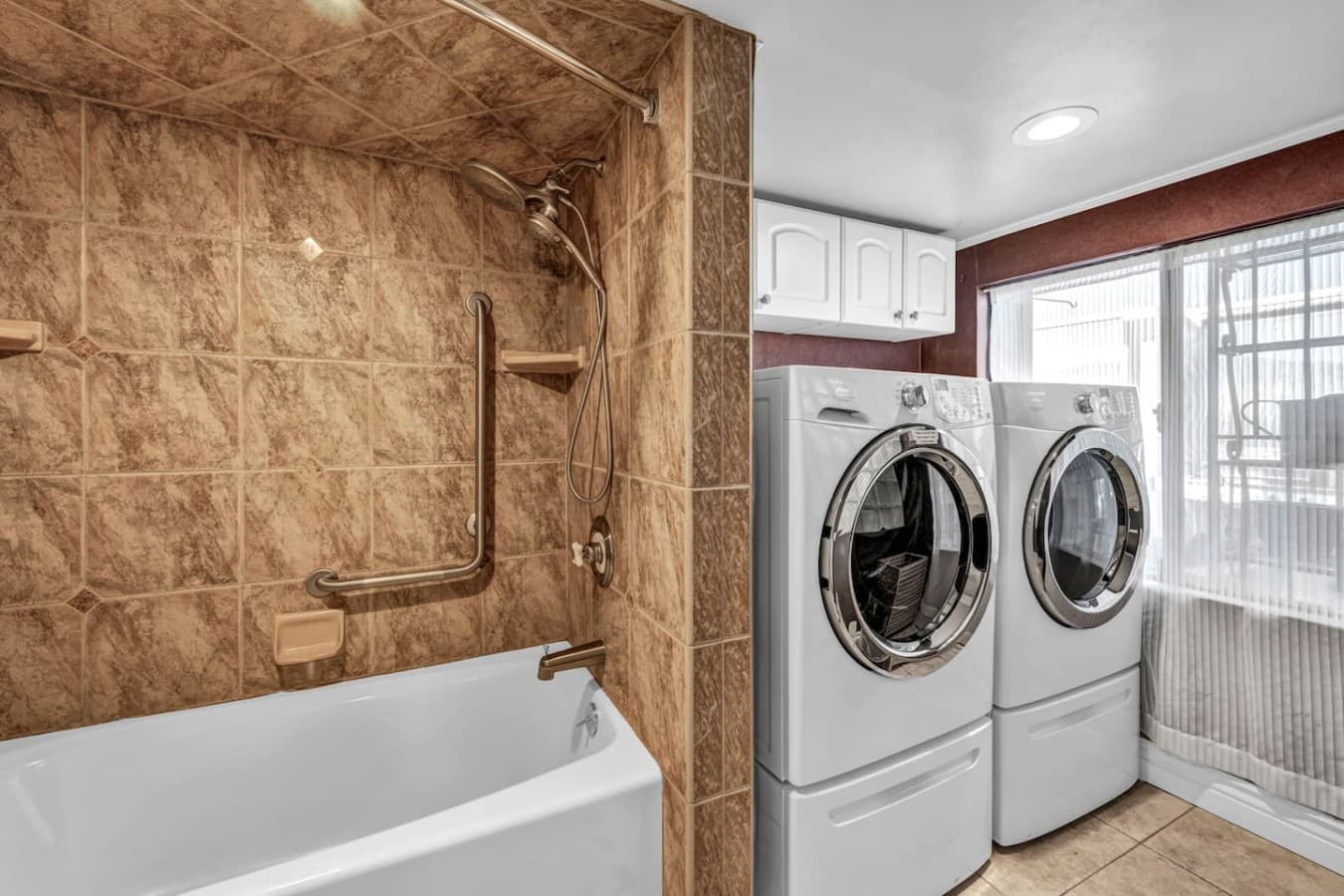 Washer and dryer located in the full bathroom.