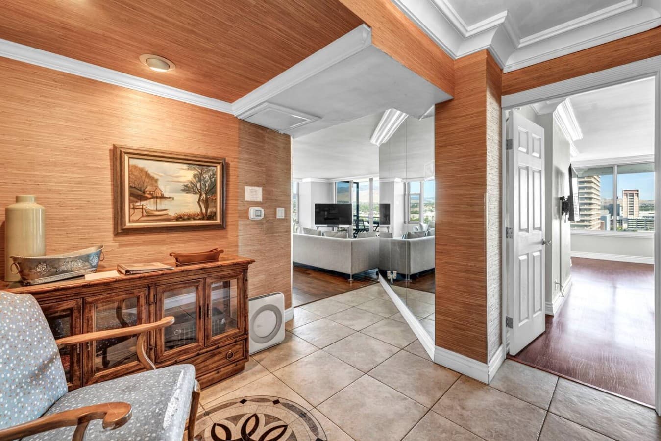 A welcoming entry that opens into bright, spacious living with city views beyond.