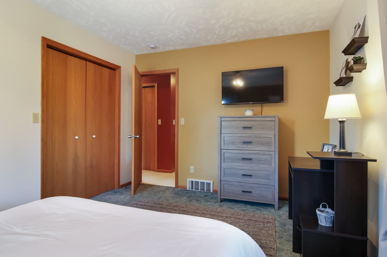 Bedroom Retreat: Enjoy modern decor, ample storage, and a TV for relaxing evenings!