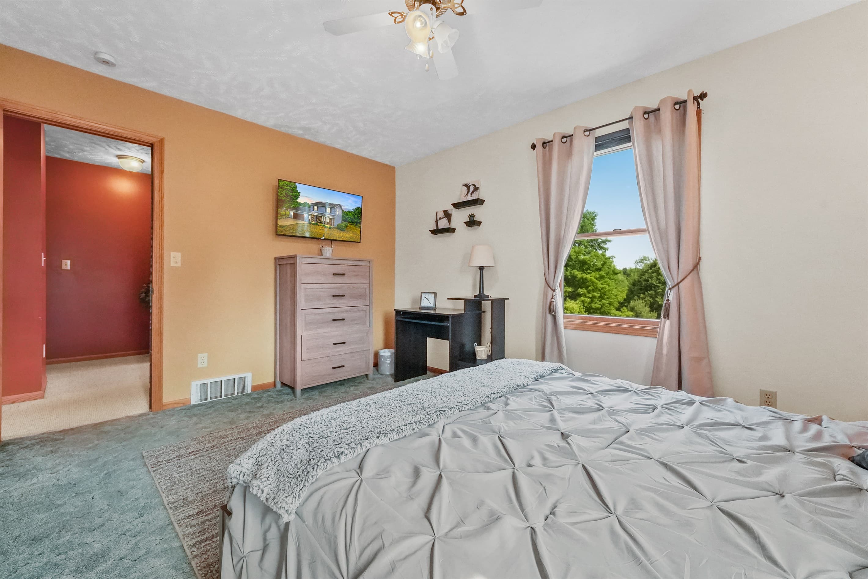 Main Bedroom: Enjoy serene views and unwind with your favorite shows on the flat screen TV!
