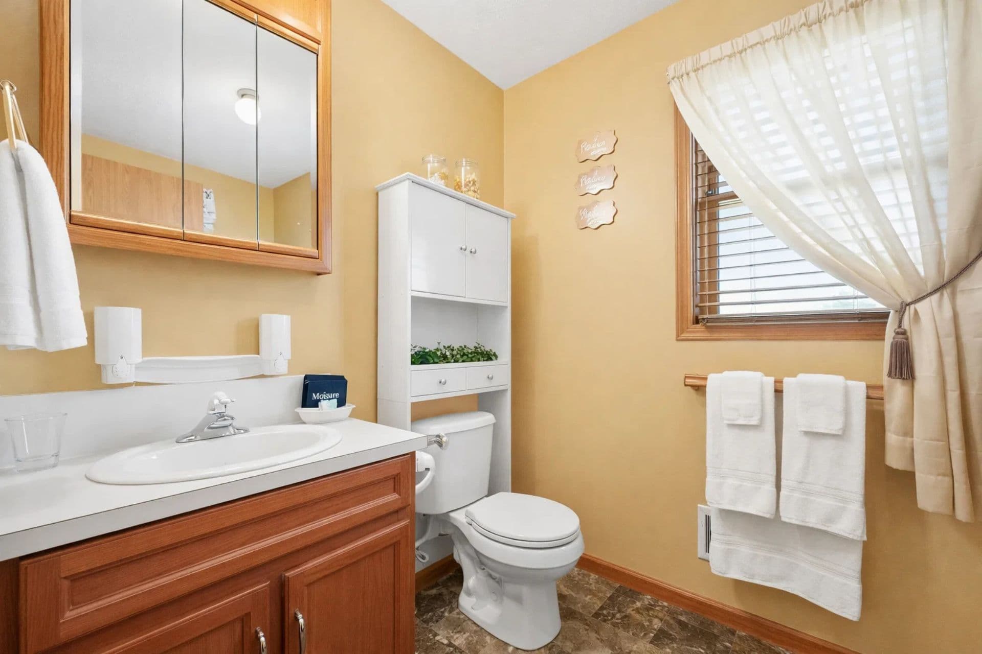 Half Bathroom: Bright space with warm tones and charming decor, perfect for quick refreshes!