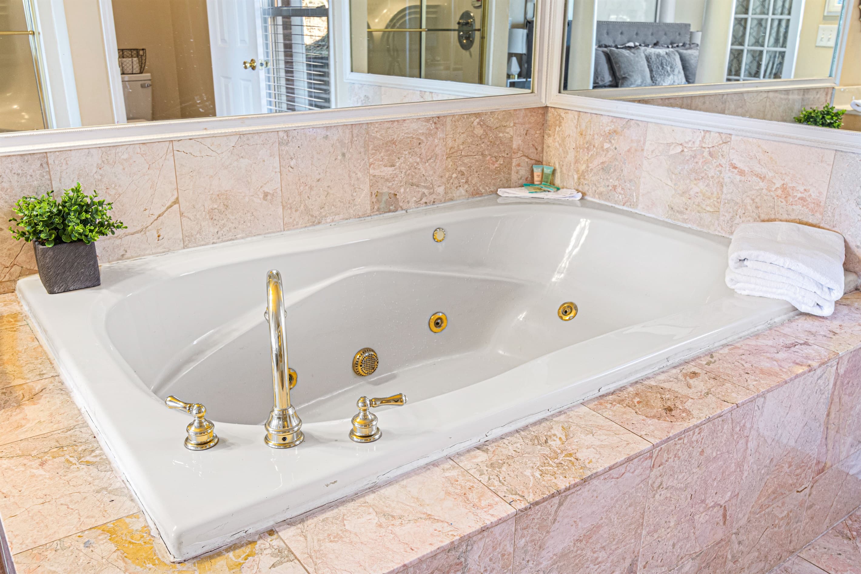 Bathroom Oasis: Indulge in relaxation with a luxurious jacuzzi tub and elegant marble accents!