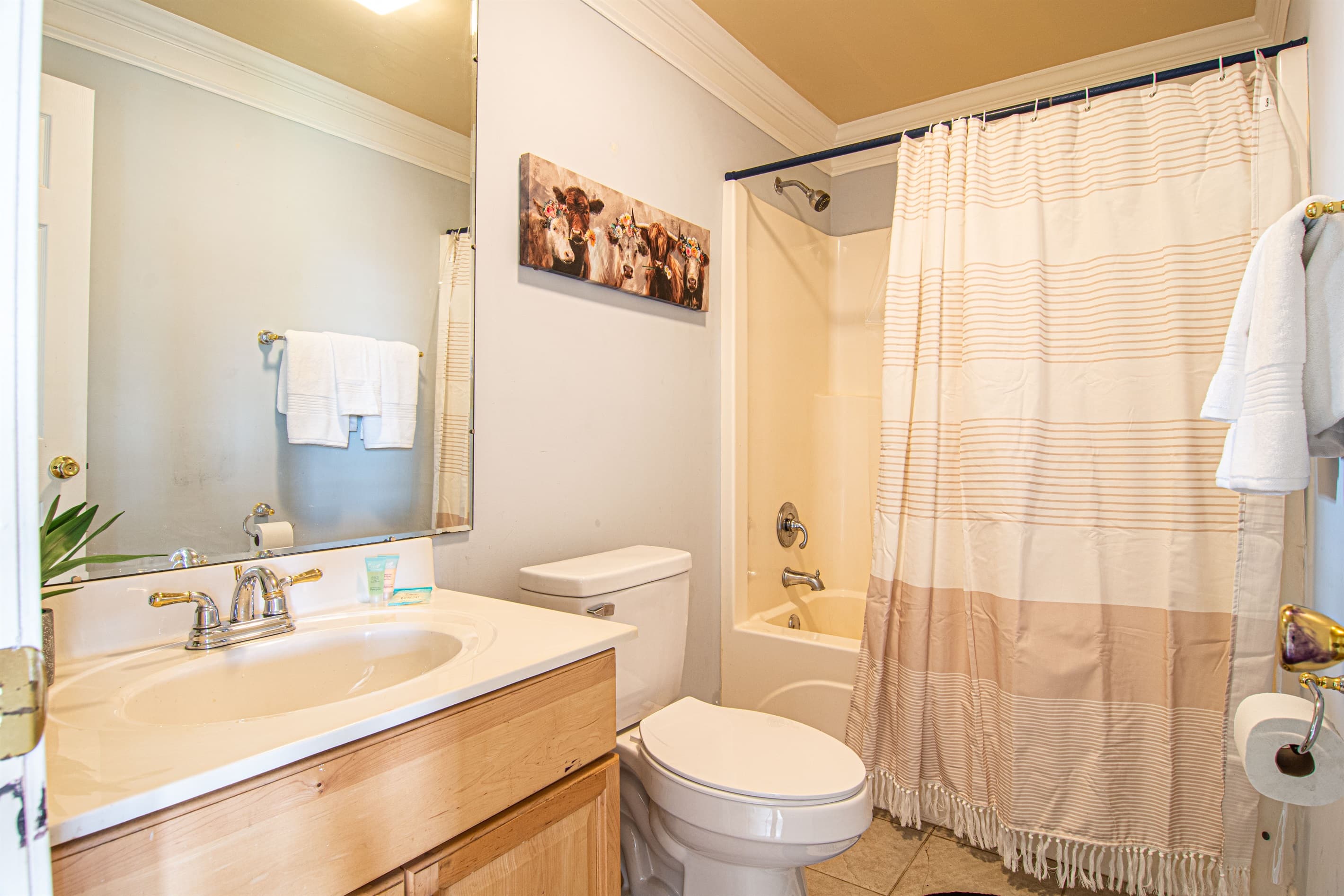 Bathroom: Bright and inviting, featuring modern finishes and charming cow-themed decor!