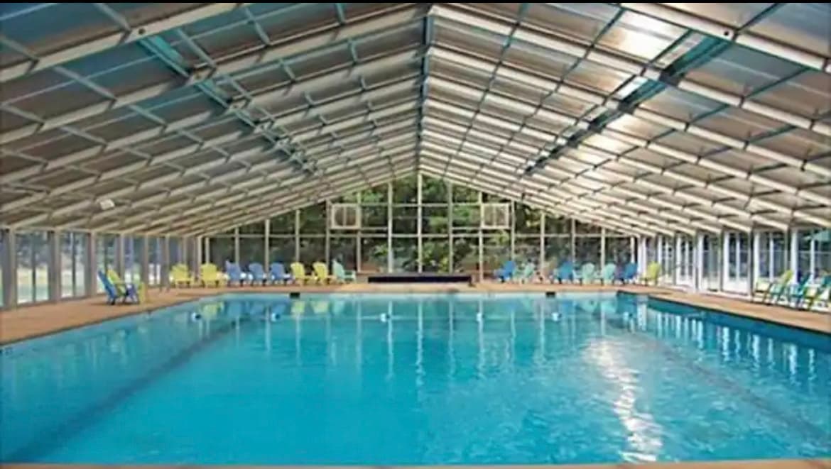 Covered pool at the recreational center. The pool is heated in winter. Indoor Pool Paradise: Splash and relax year-round in our stunning heated pool area!