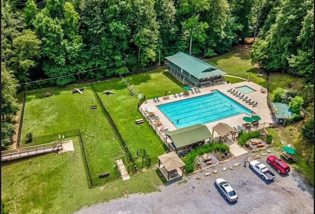 Outdoor resort pool-1. Outdoor Oasis: Dive into relaxation at our spacious resort pool, surrounded by nature’s beauty!