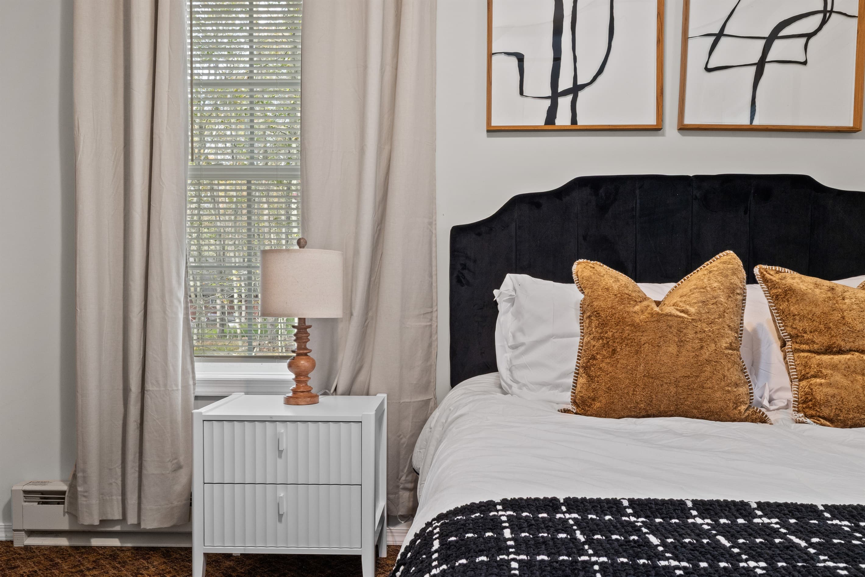 Elegant Bedroom Retreat: Stylish decor, plush accents, and natural light for a serene escape!