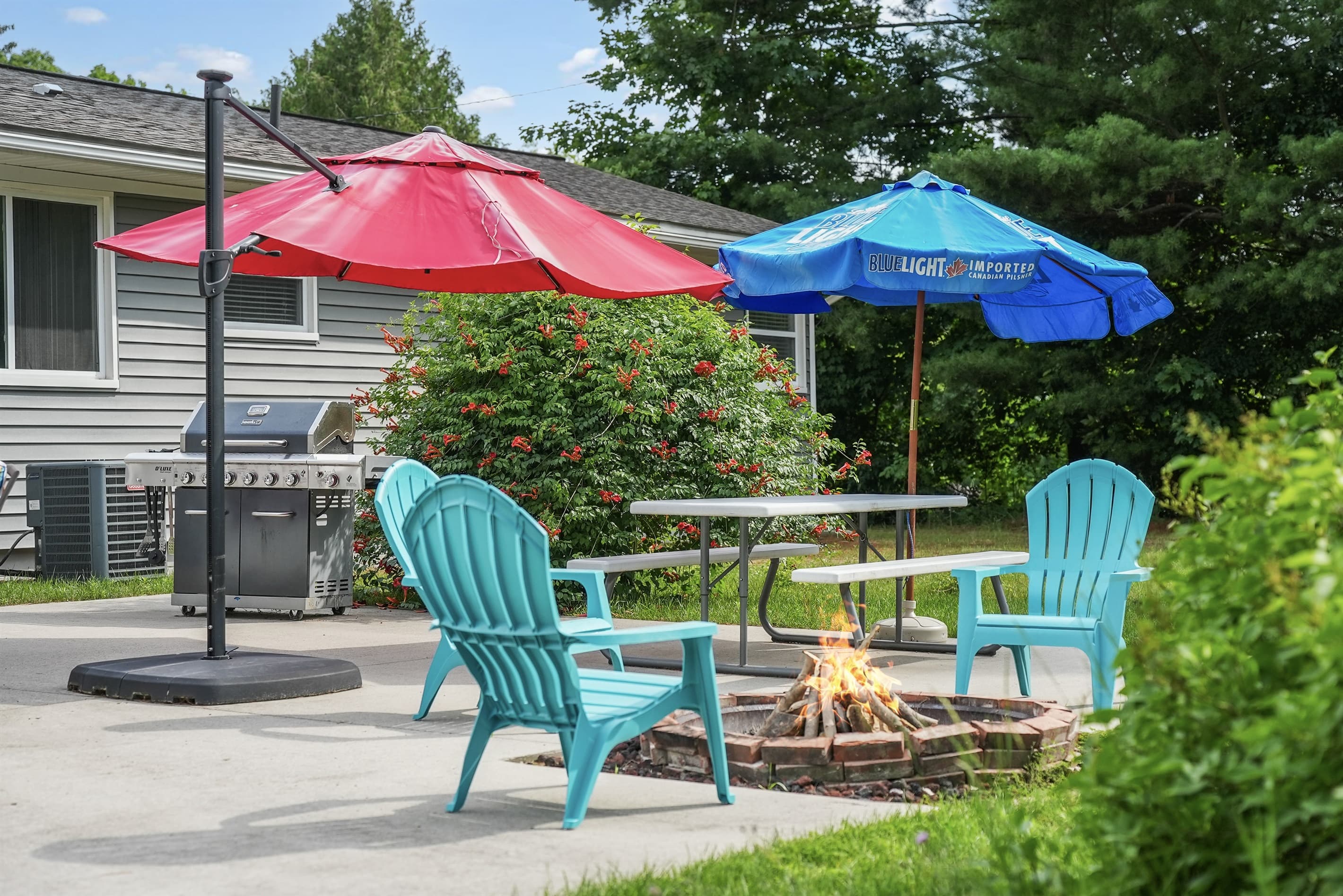 Outdoor Lounge: Bright umbrellas shade a fabulous firepit, perfect for s'mores and starry nights!