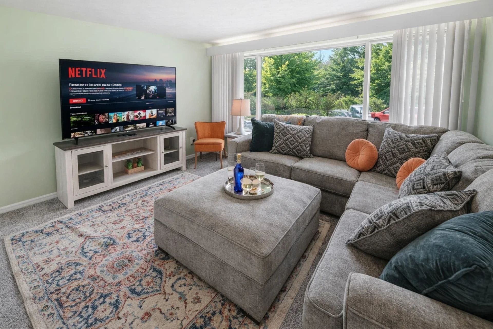 Spacious living room featuring a sleek 65 inch TV, ideal for entertainment and cozy time at home