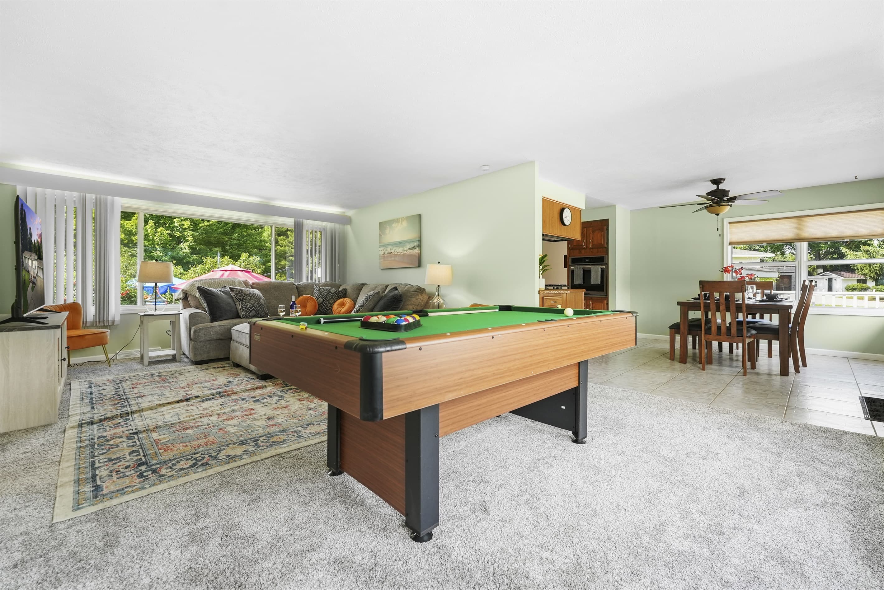 Entertainment- ready living room with a pool table, perfect for friendly games and gatherings