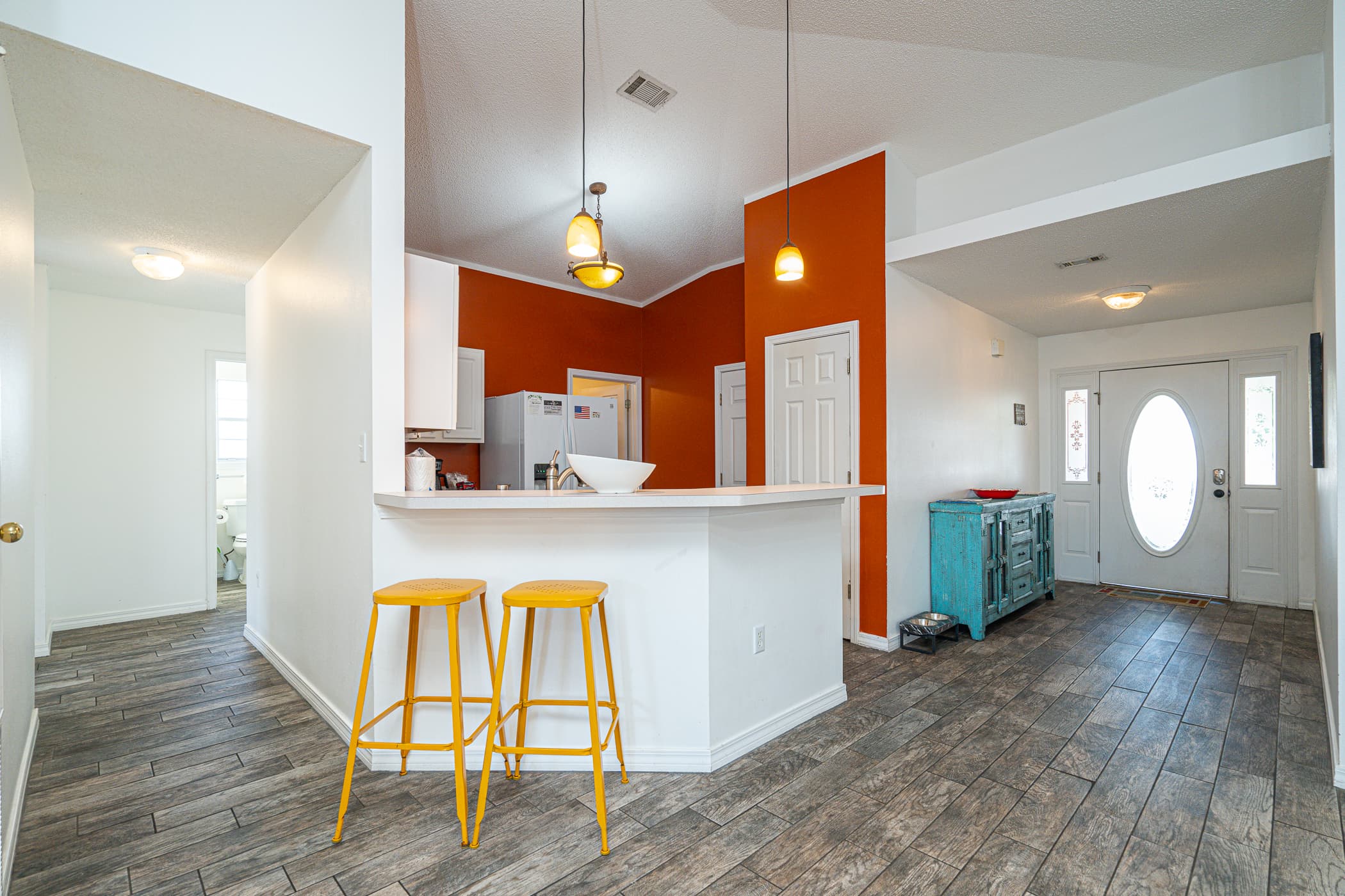 Open Concept Kitchen: Bright, airy space with colorful accents and stylish seating—perfect for gatherings!