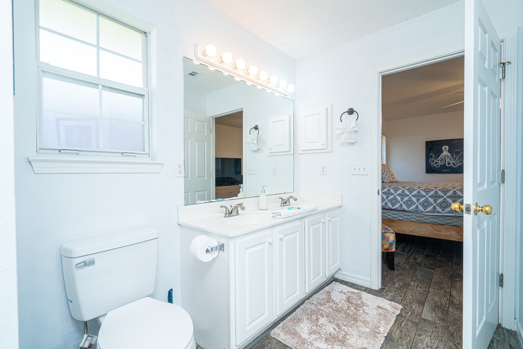 Ensuite with main bedroom - Ensuite Bathroom: Bright and inviting space with dual sinks, perfect for refreshing mornings!