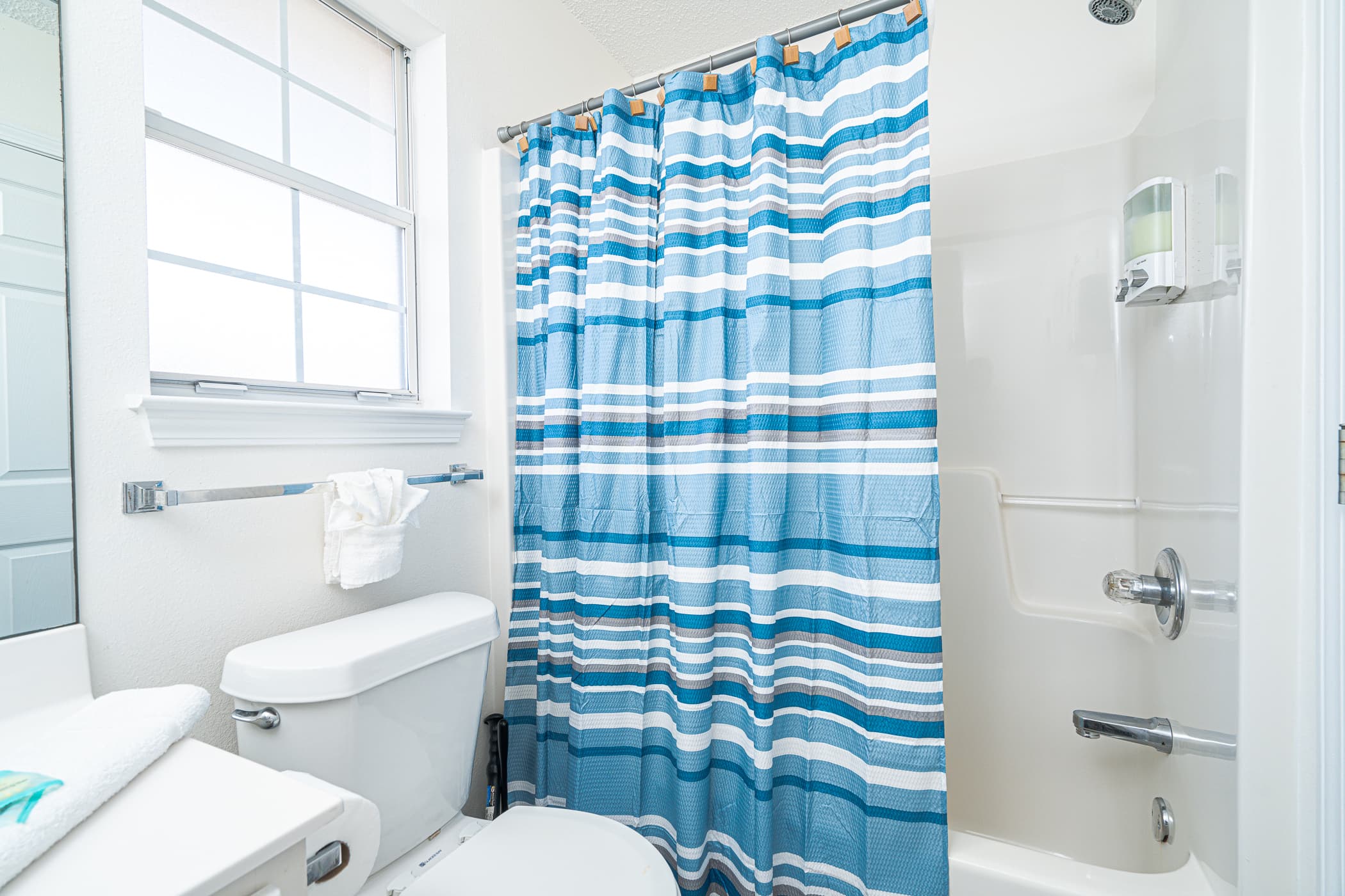Bathroom Retreat: Bright and airy space with playful stripes, inviting relaxation after your adventures!
