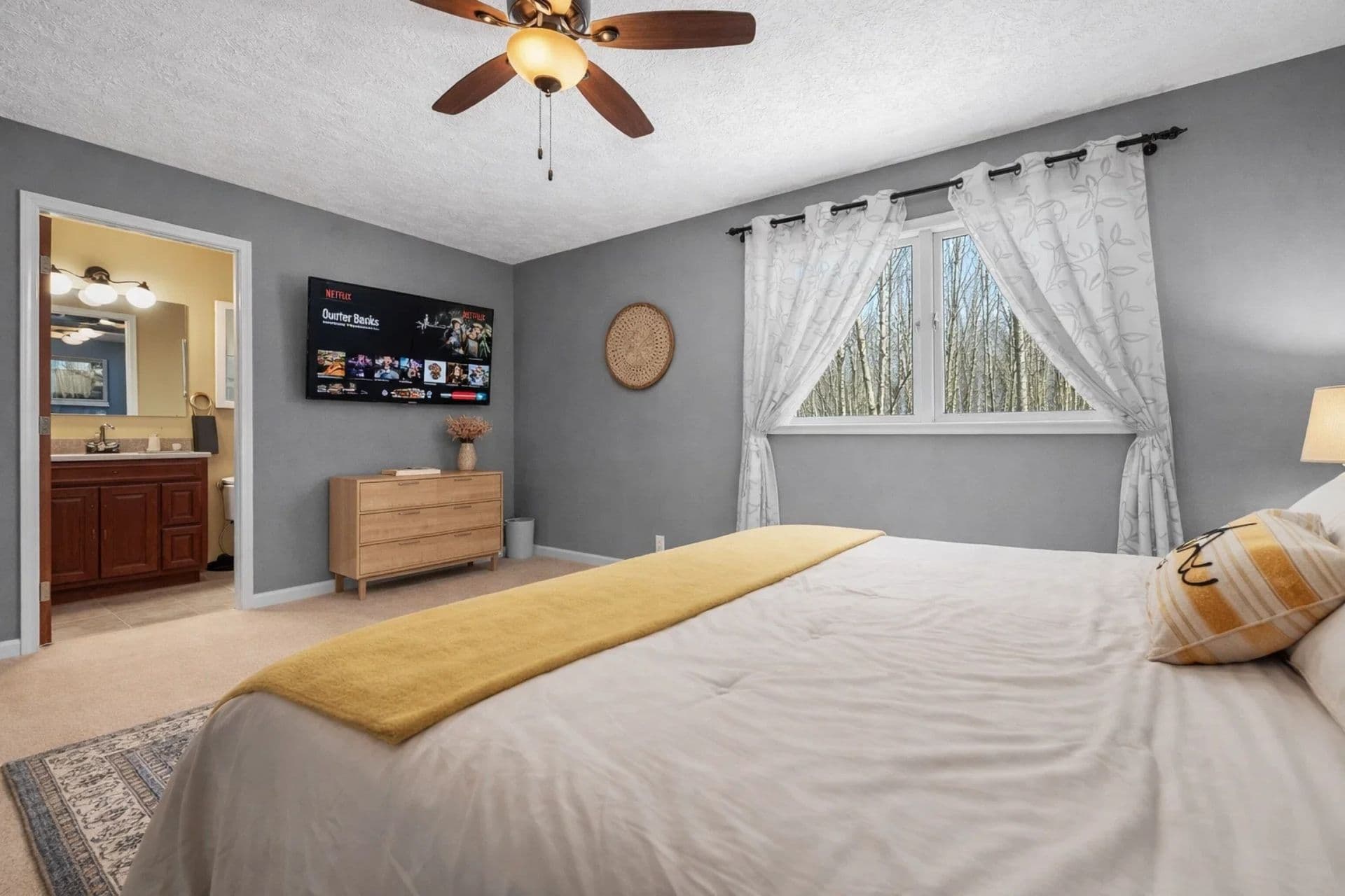 Main Bedroom: Bright room with a lovely view, TV, and warm decor for your relaxation!