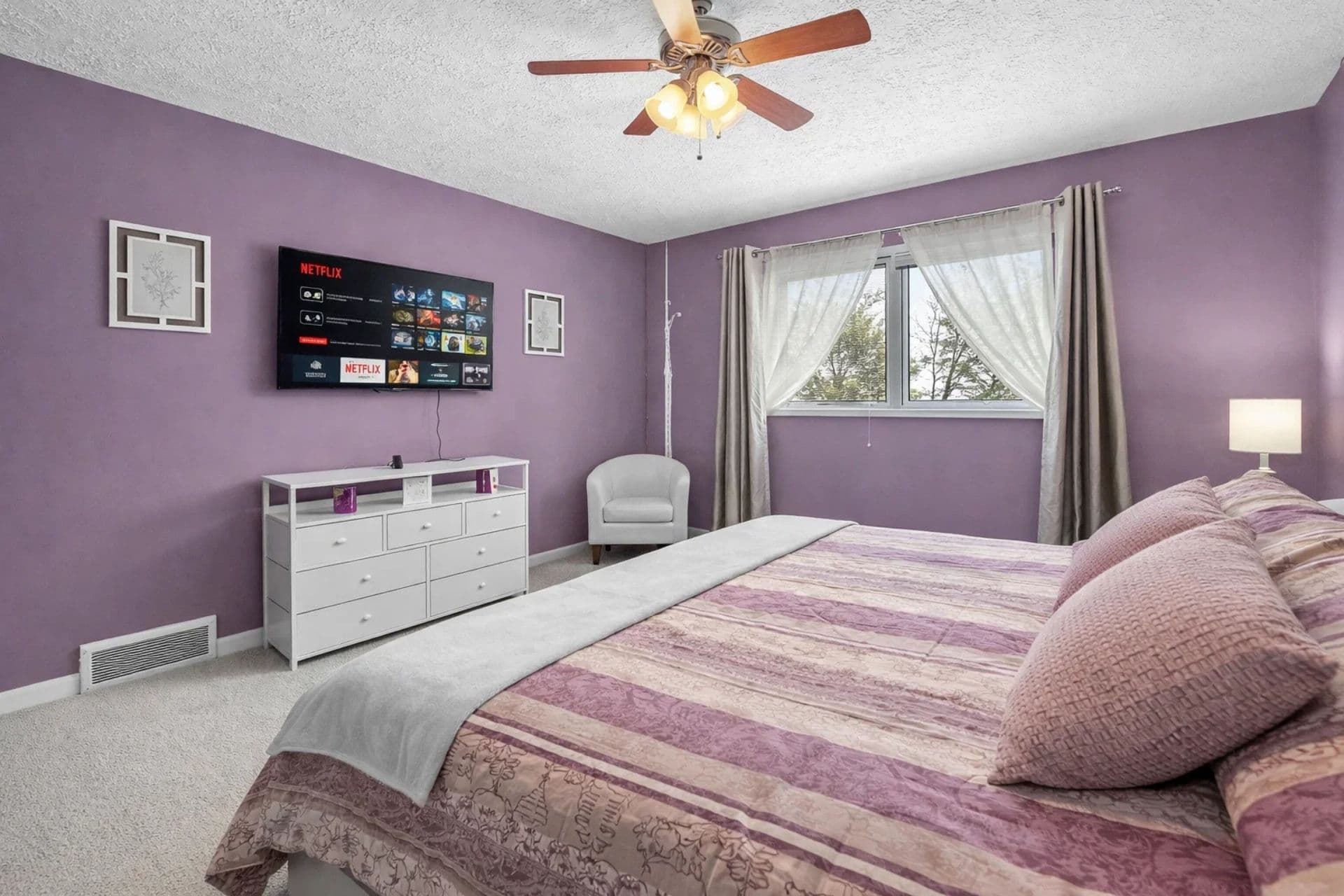 Bedroom Retreat: Enjoy movie nights on the flat-screen with elegant decor and serene views!