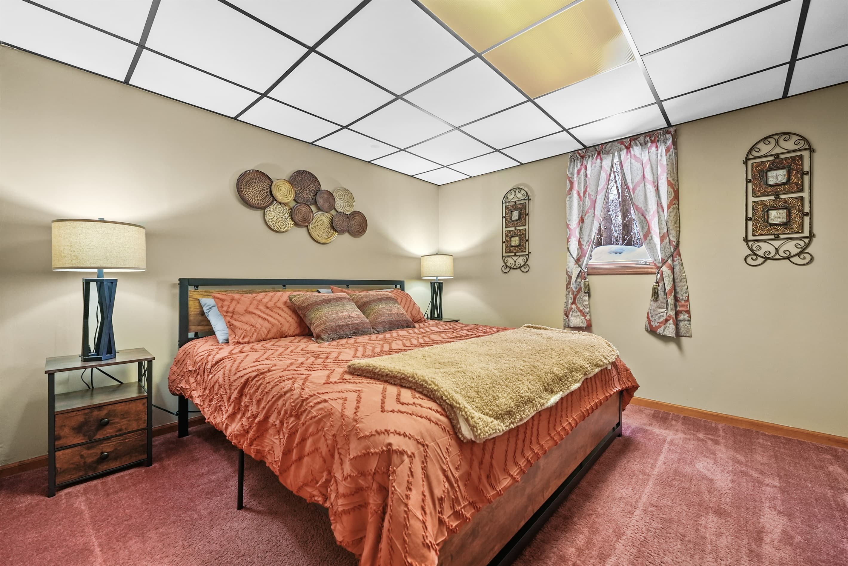 Spacious Bedroom Retreat: King bed, vibrant decor, and warm lighting for ultimate relaxation!
