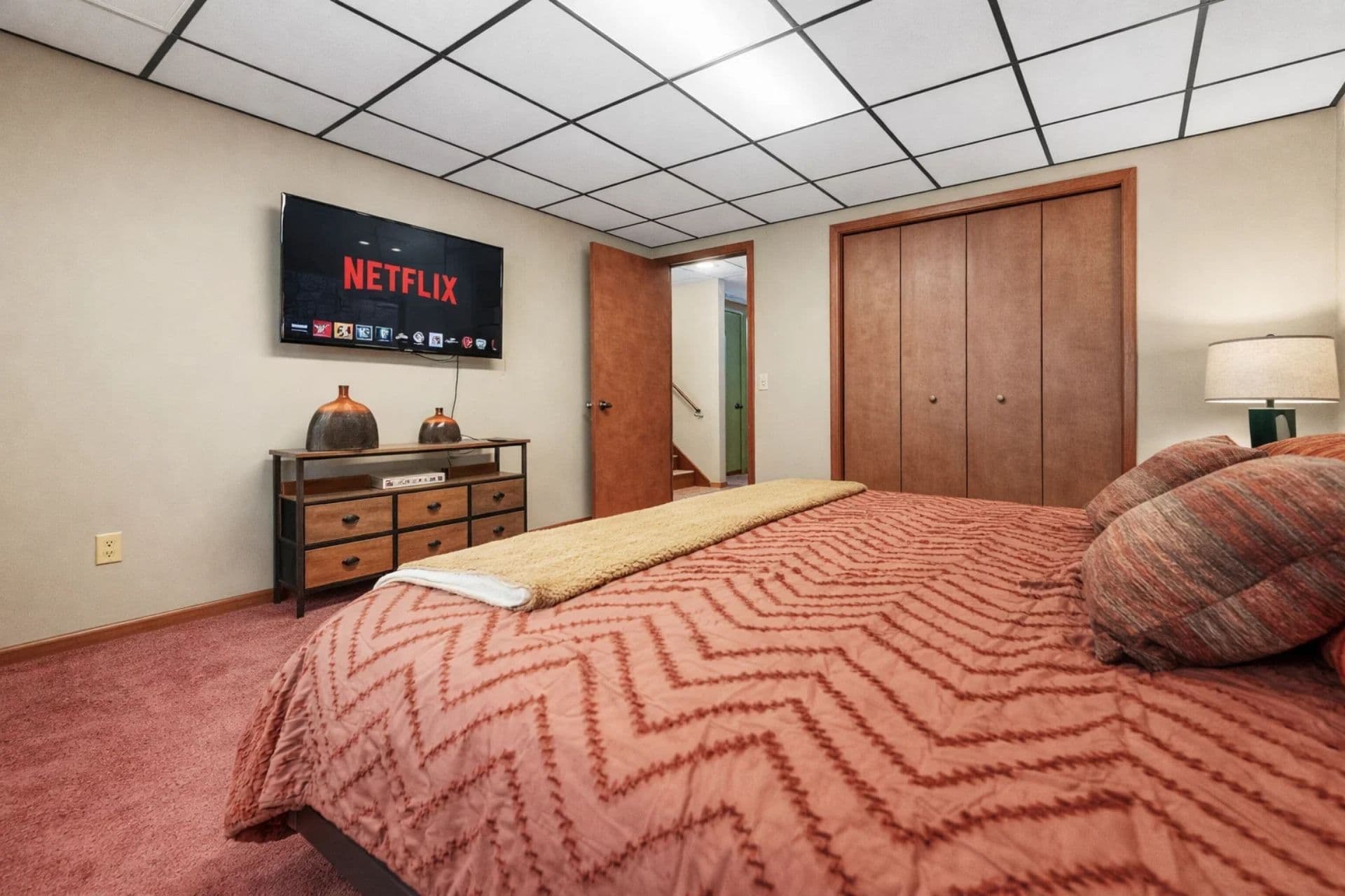 Bedroom Retreat: Elegant king bed paired with a flat-screen TV invites relaxation and entertainment.