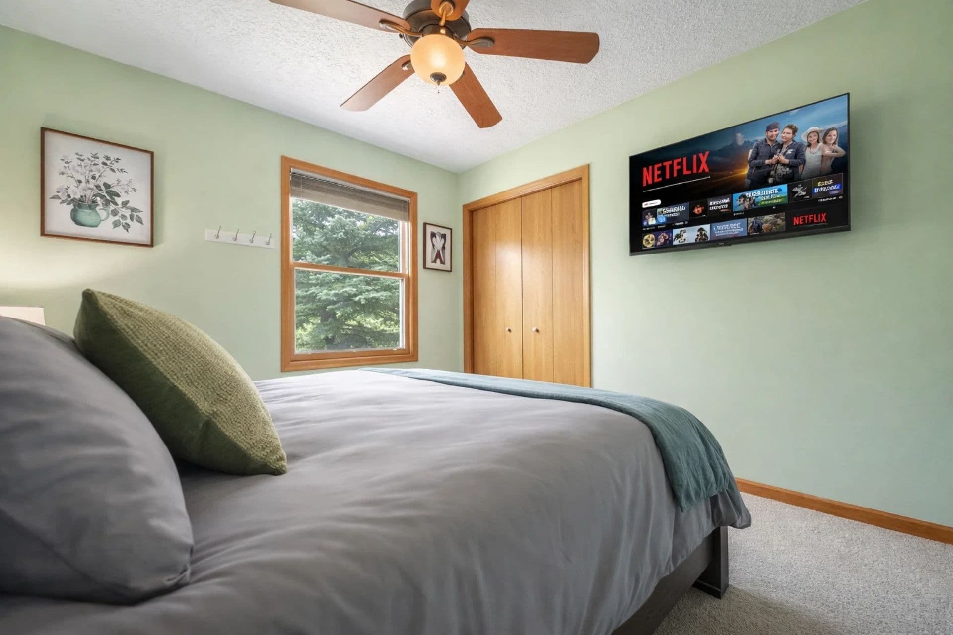 Bedroom Retreat: Bright green walls and art create a refreshing haven with plush bedding and elegant decor.