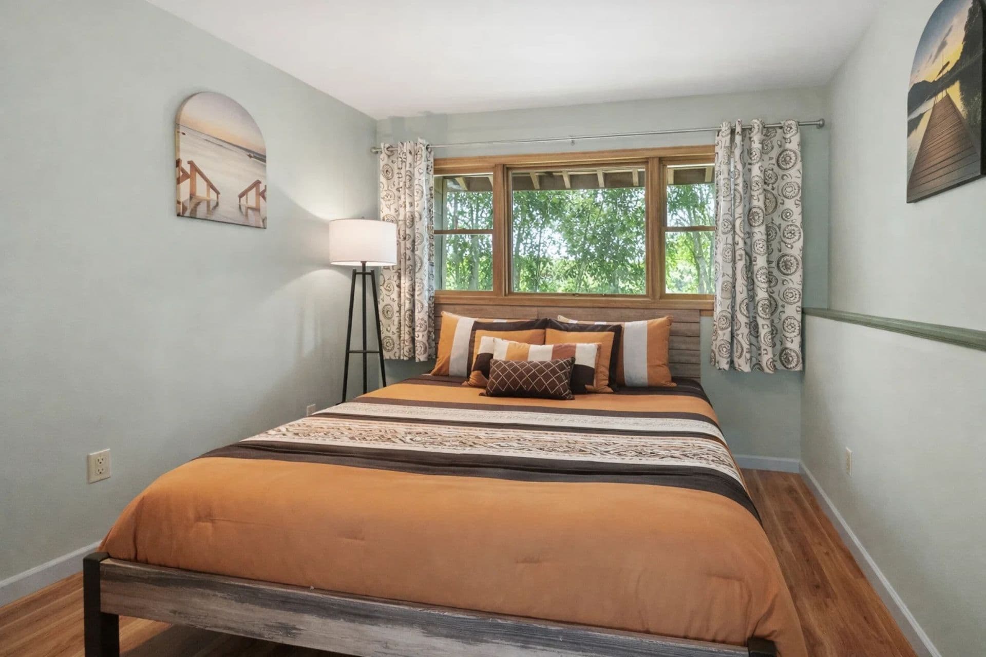 Downstairs Bedroom: Bright and inviting retreat with a queen bed and nature views!