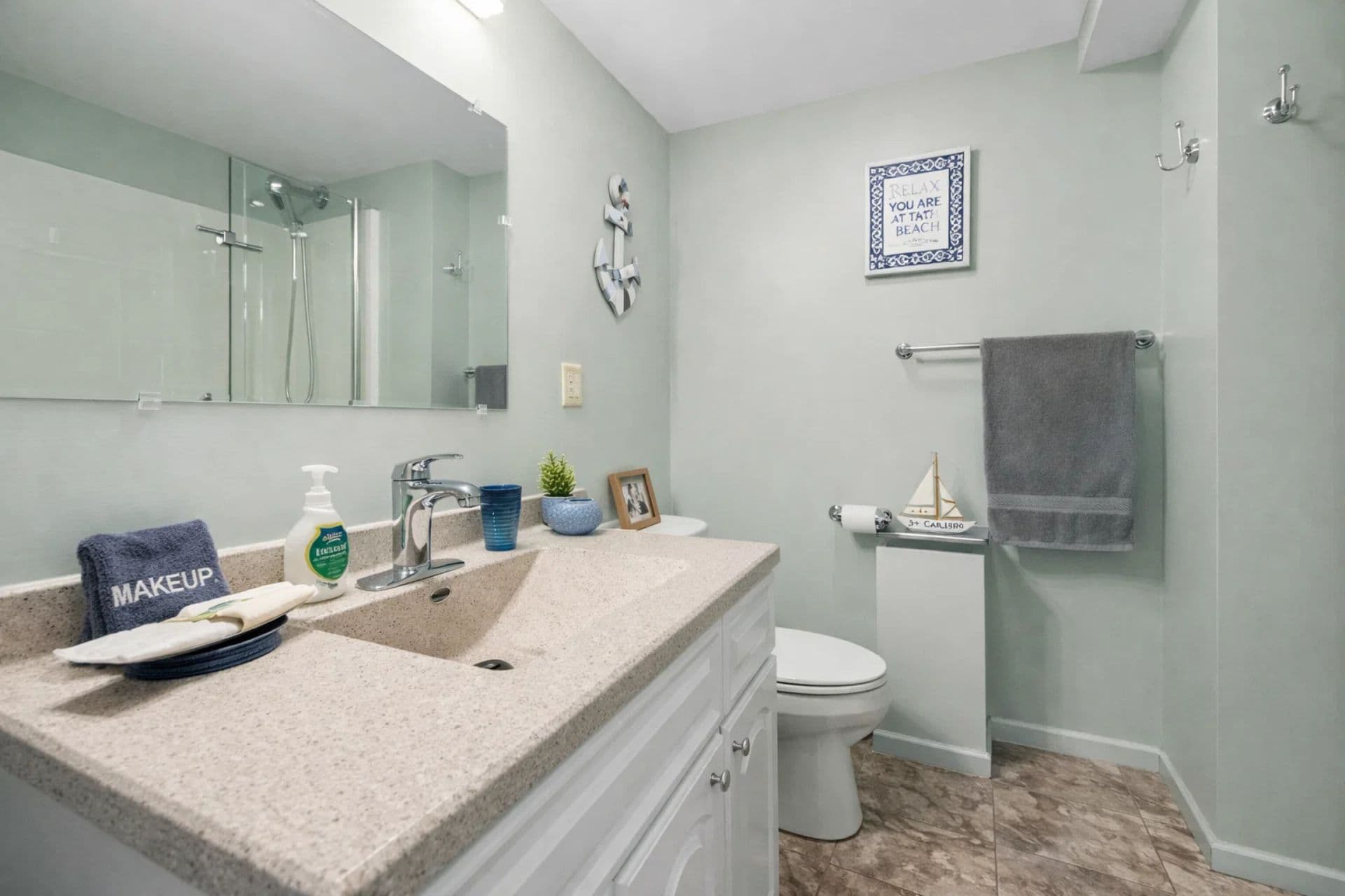 2nd full bathroom downstairs - Modern Full Bathroom: Refresh in style with sleek finishes and nautical decor! Perfect for relaxation.