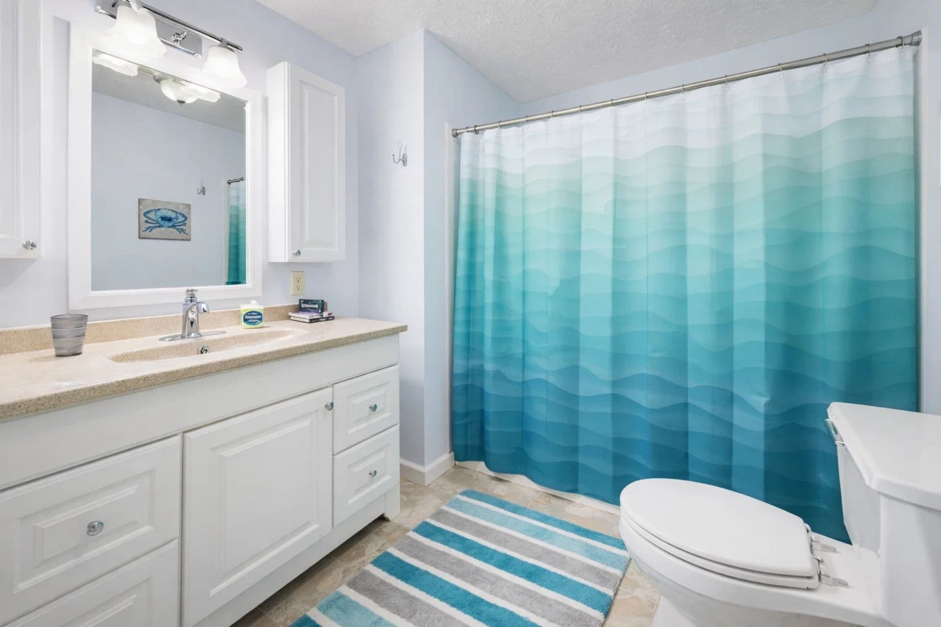 Full Bathroom: Refresh in this vibrant retreat with beachy decor and modern amenities!