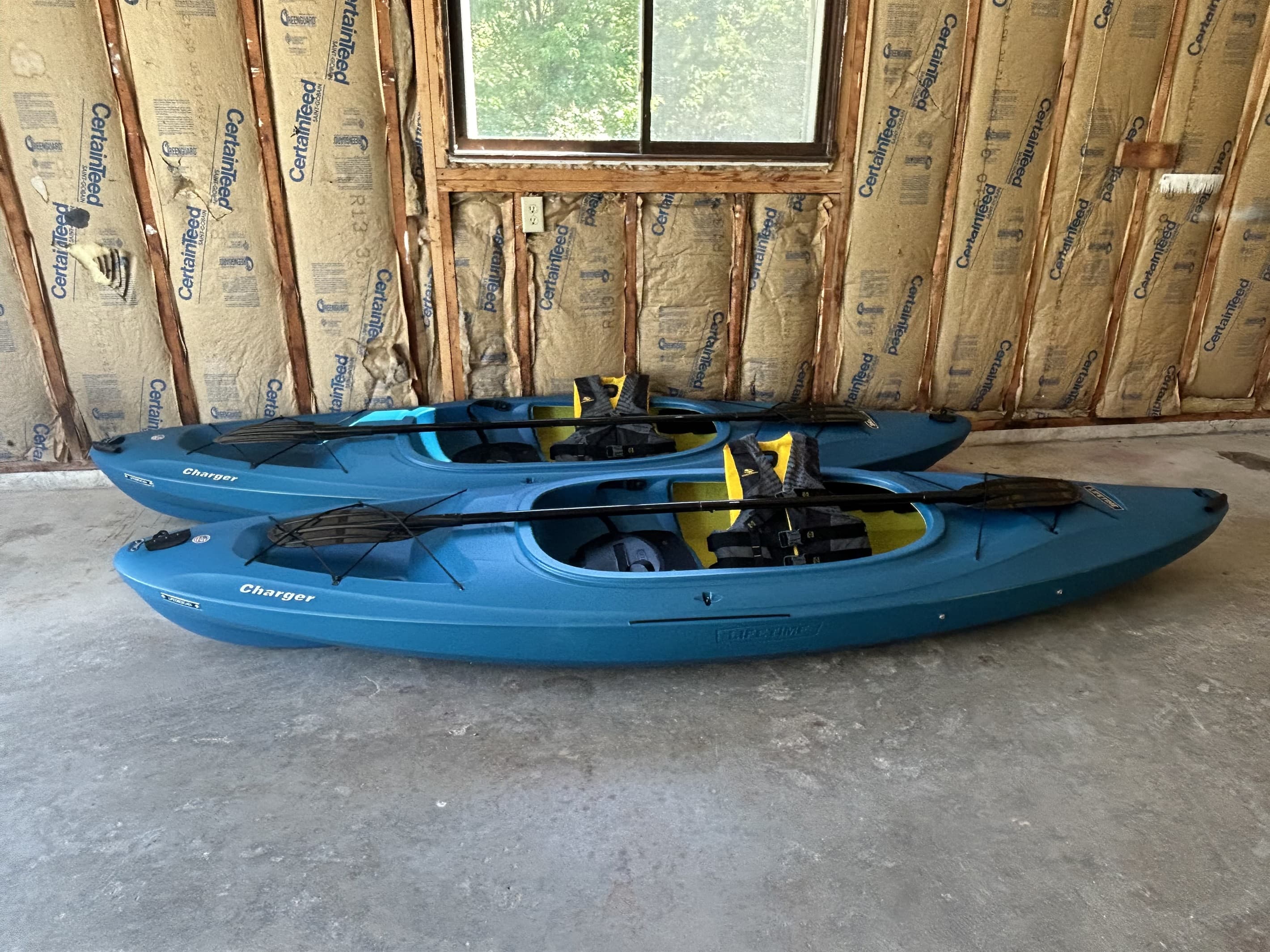 Kayak Adventure: Two vibrant kayaks ready for your next water escapade in scenic Traverse City!