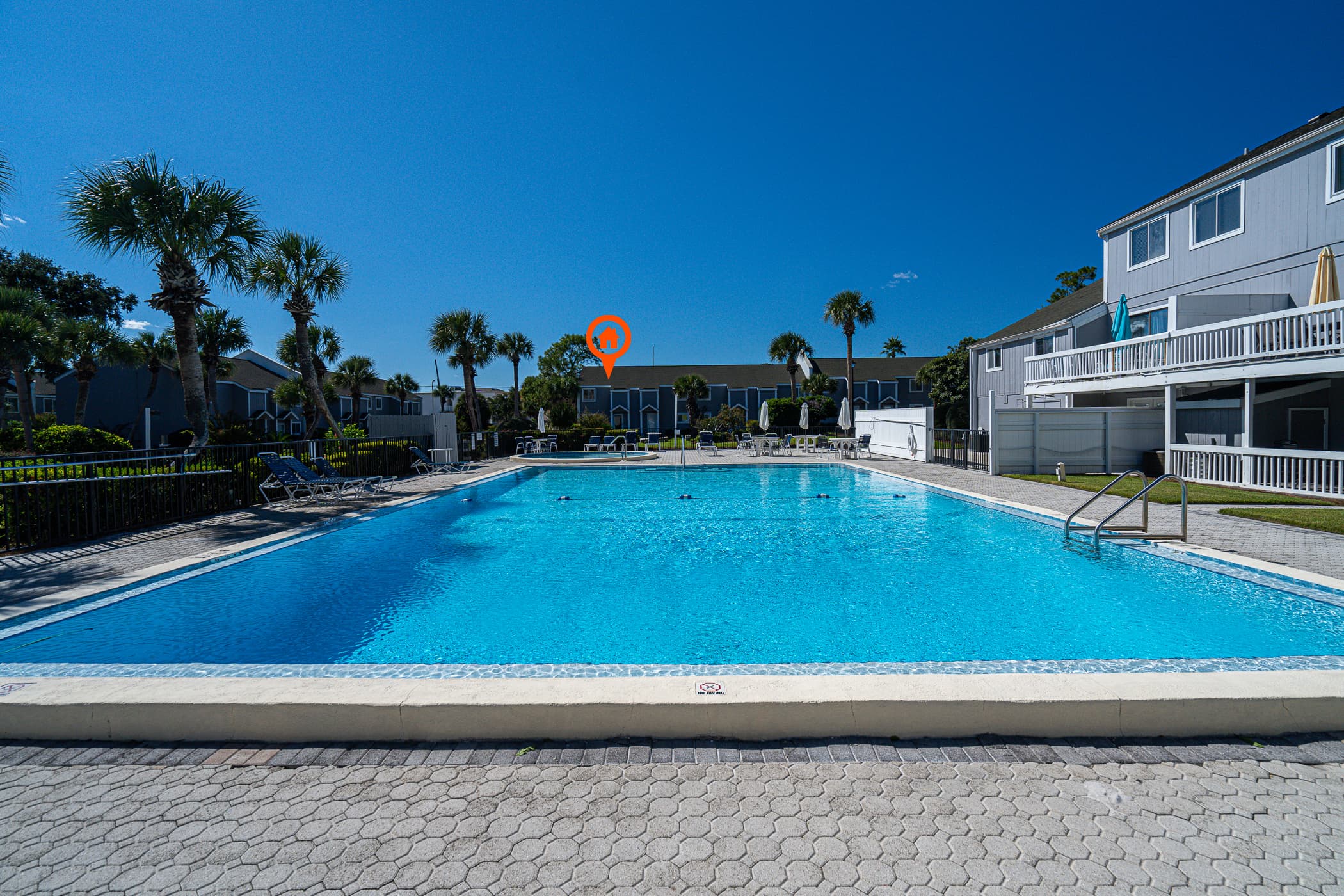 Poolside Paradise: Dive into fun just steps from your door, with the sun shining bright! Resort swimming pool is right across from home